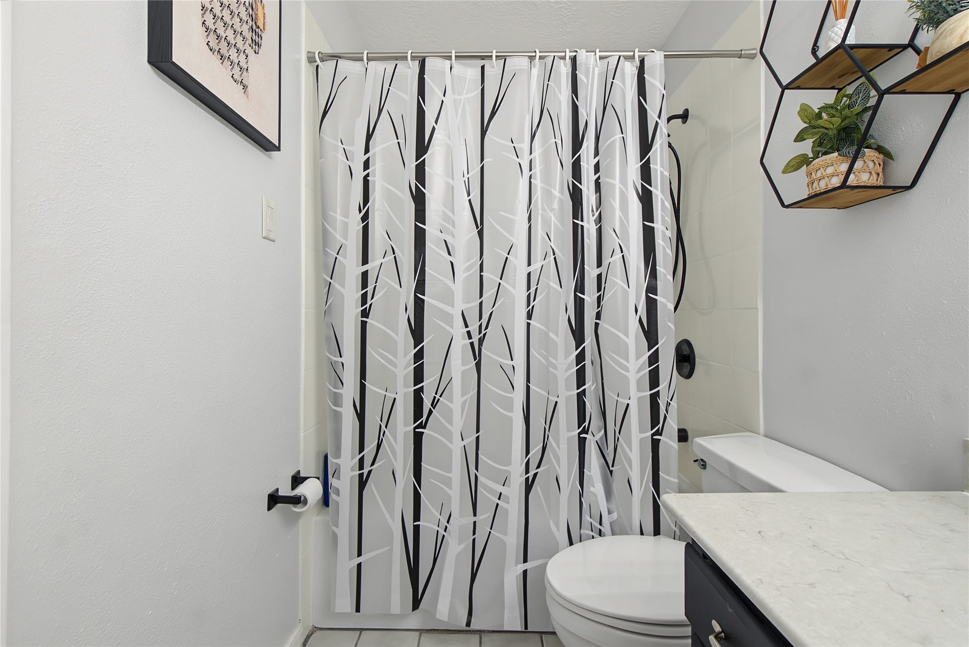 Additional bathroom view highlighting the tub/shower combination and neutral finishes.
