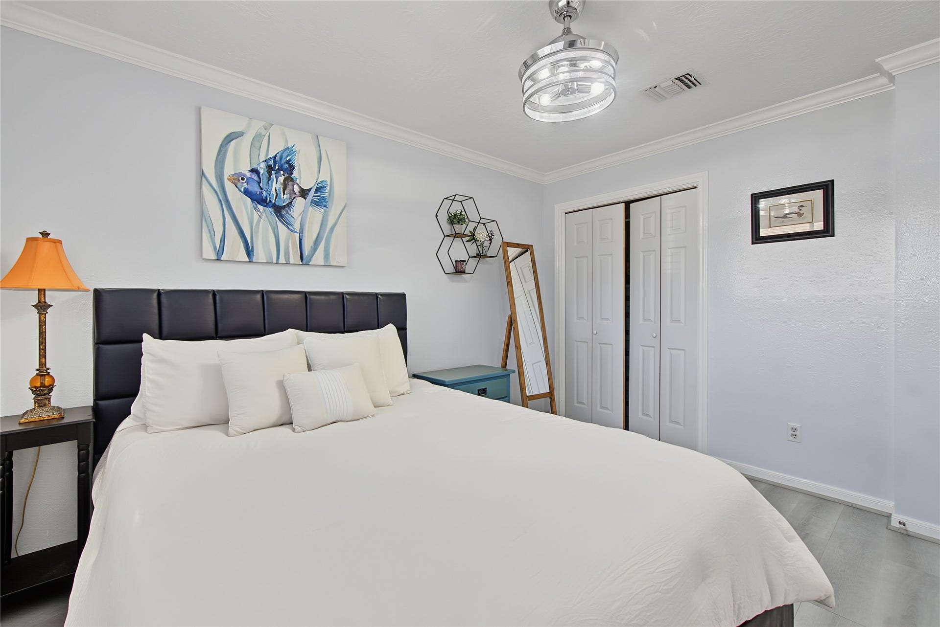 Another view of the spacious primary bedroom featuring a large closet and attractive finishes.