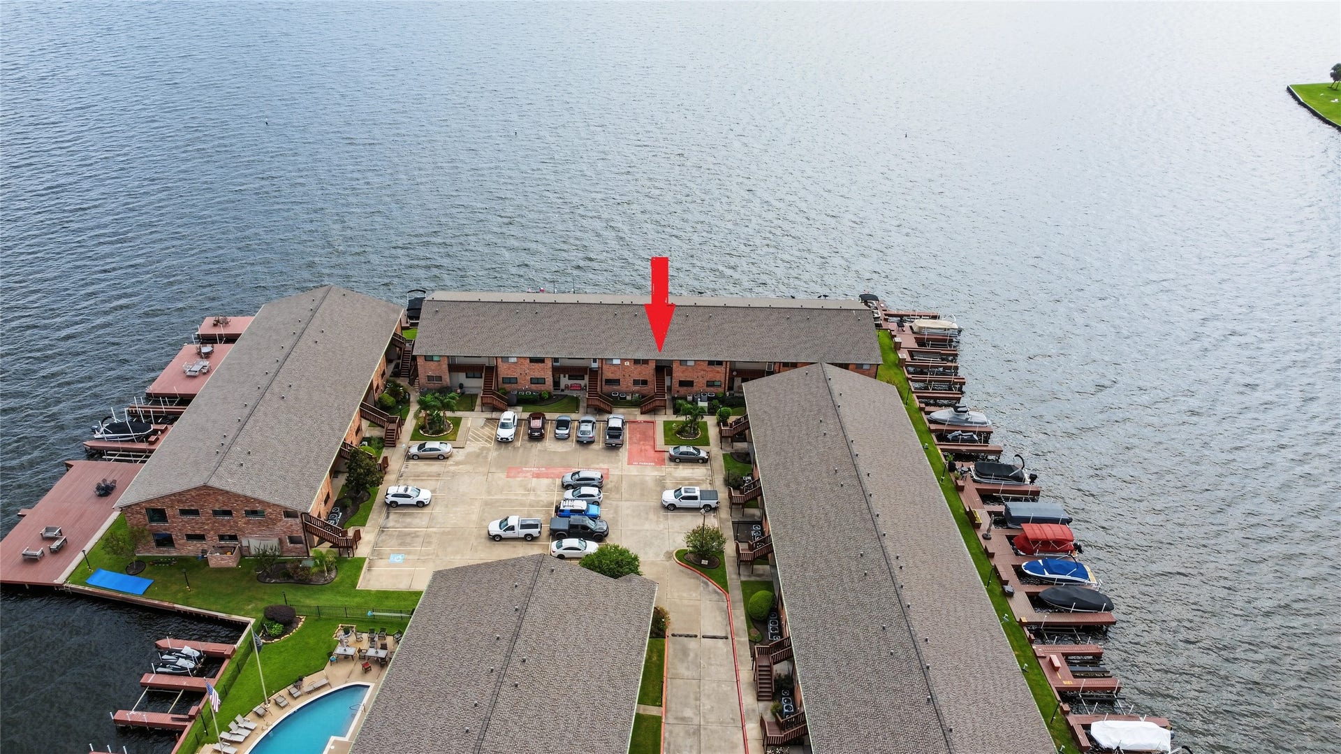 Aerial perspective showcasing the peninsula setting, expansive Lake Conroe shoreline, and surrounding waterfront amenities.