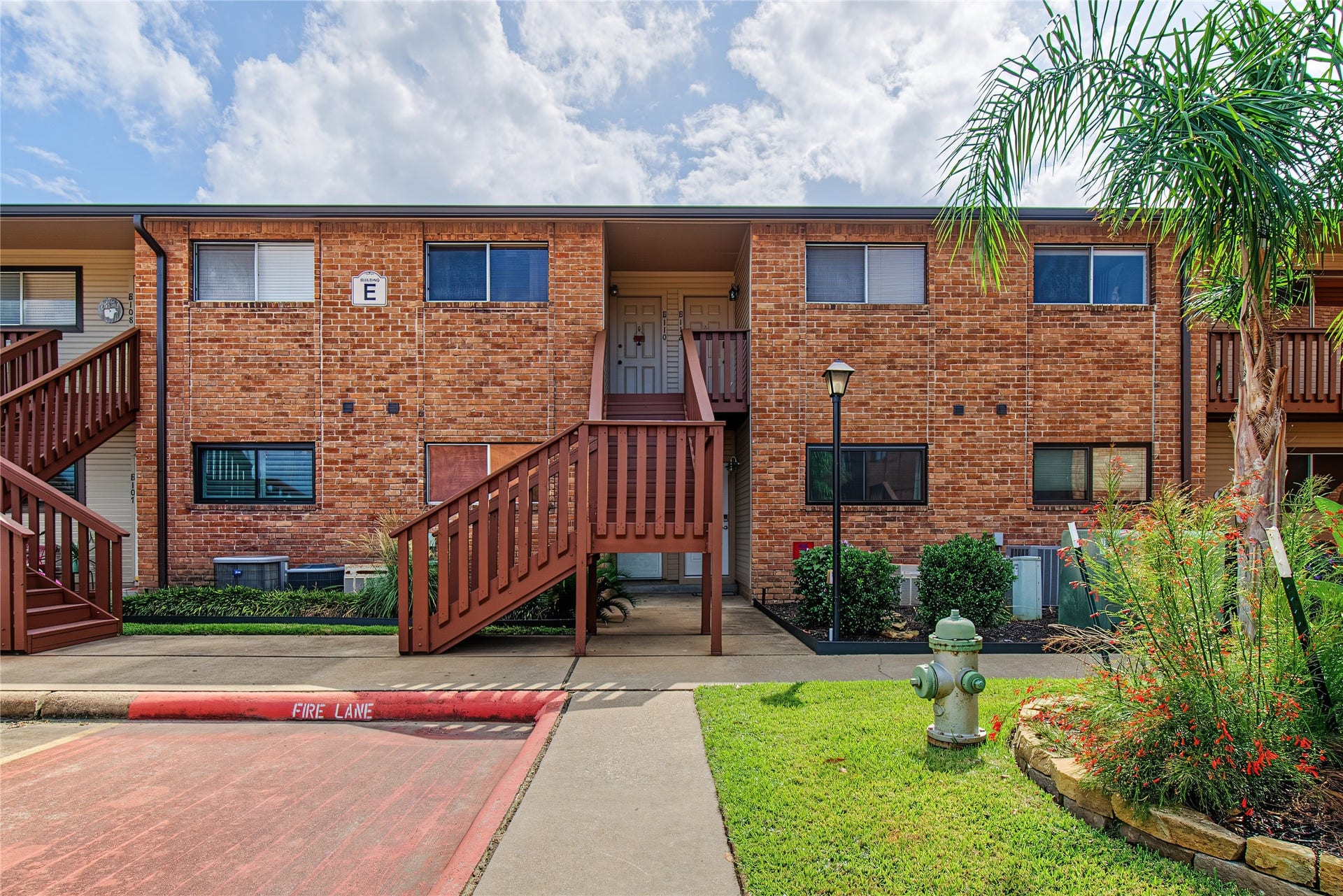 Welcoming exterior of this Lake Conroe waterfront condominium community, surrounded by mature landscaping.