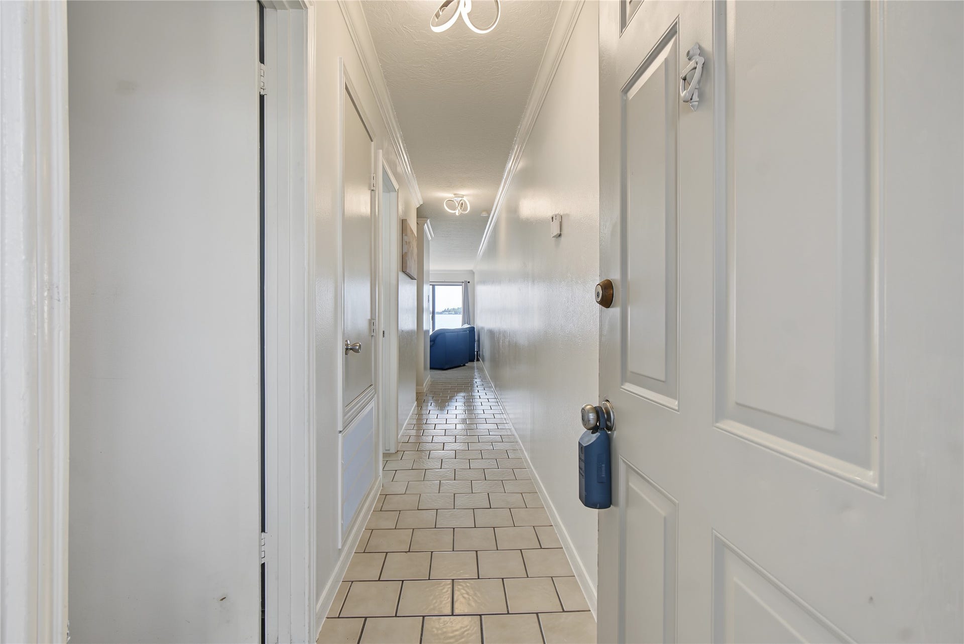 nterior entry hallway featuring tile flooring and a bright, neutral color palette.