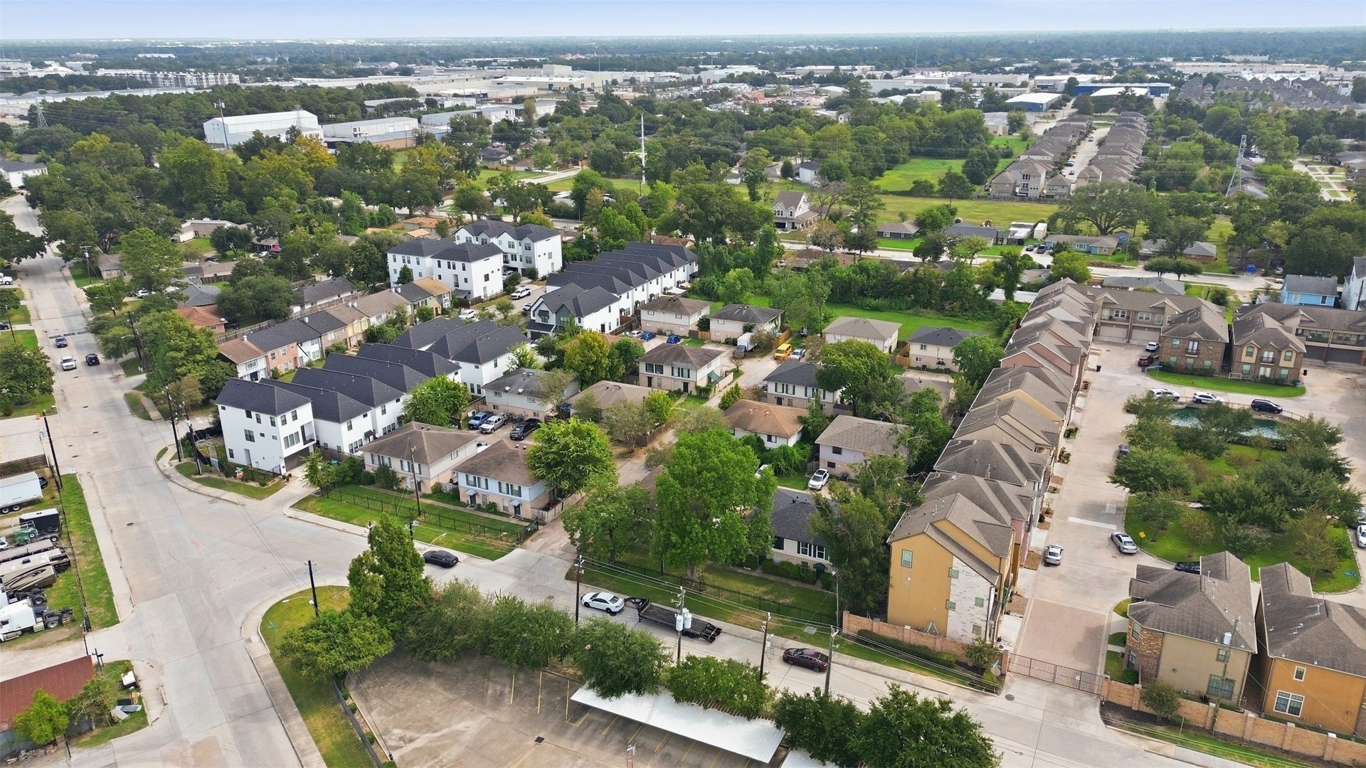 1936 Upland Drive, Houston, TX 77043 Charming neighborhood with a mix of modern townhouses and traditional homes, surrounded by lush greenery and convenient access to urban amenities.