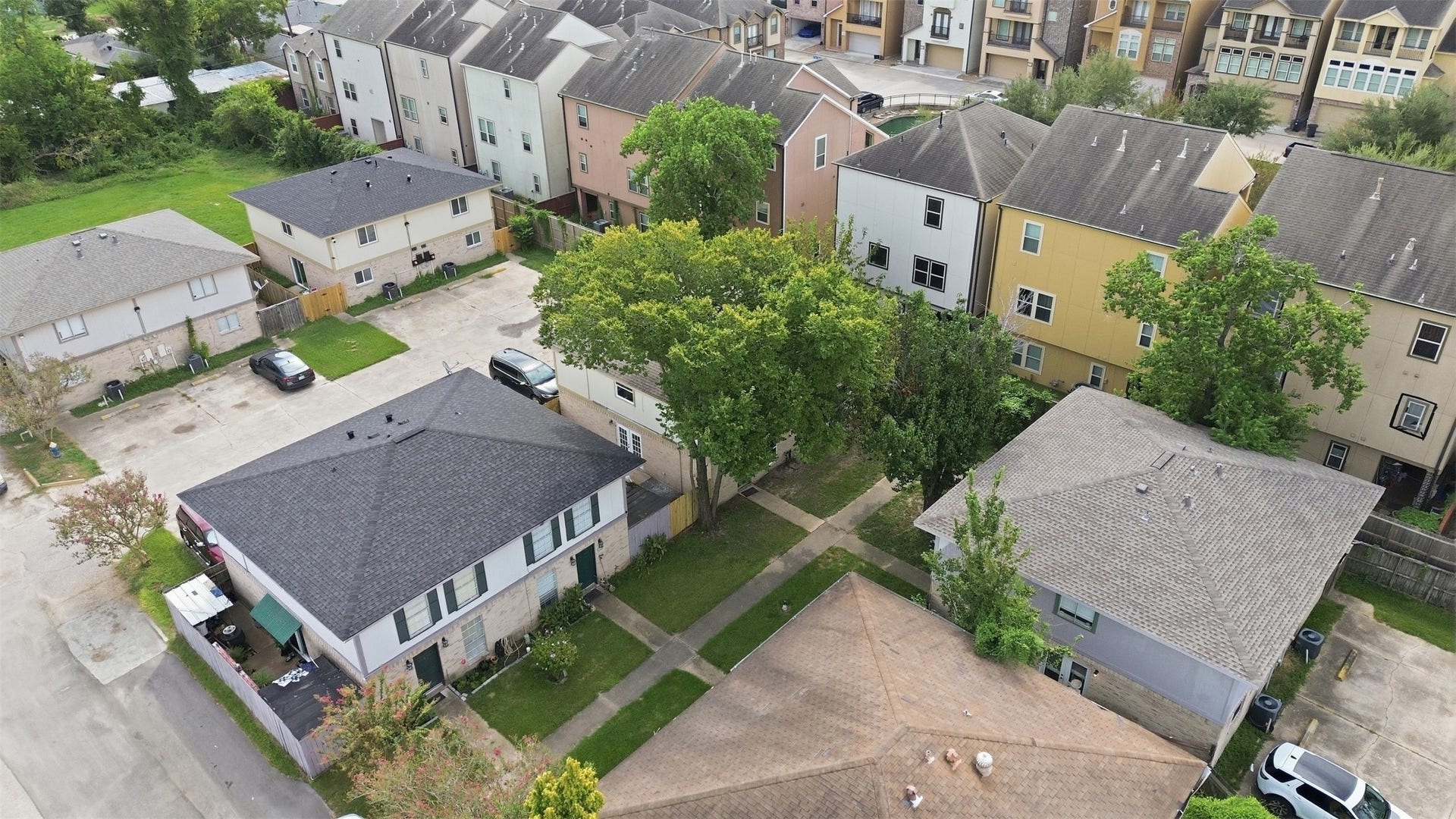 1936 Upland Drive, Houston, TX 77043 Charming neighborhood featuring a mix of townhouses and single-family homes, surrounded by greenery and offering a peaceful residential setting.