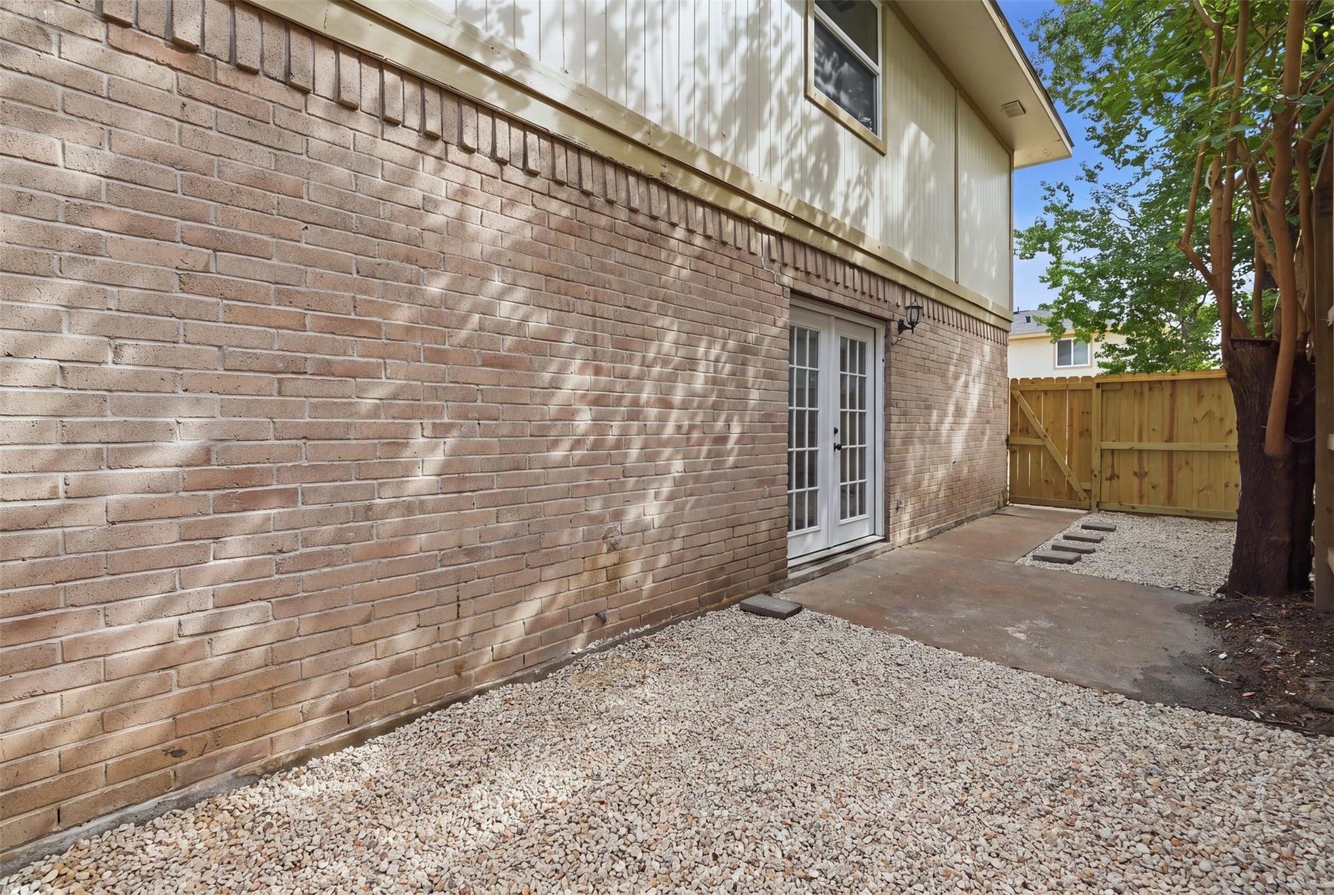 1936 Upland Drive, Houston, TX 77043 Charming brick patio with French doors opens to a private, low-maintenance outdoor space, perfect for relaxing or entertaining.