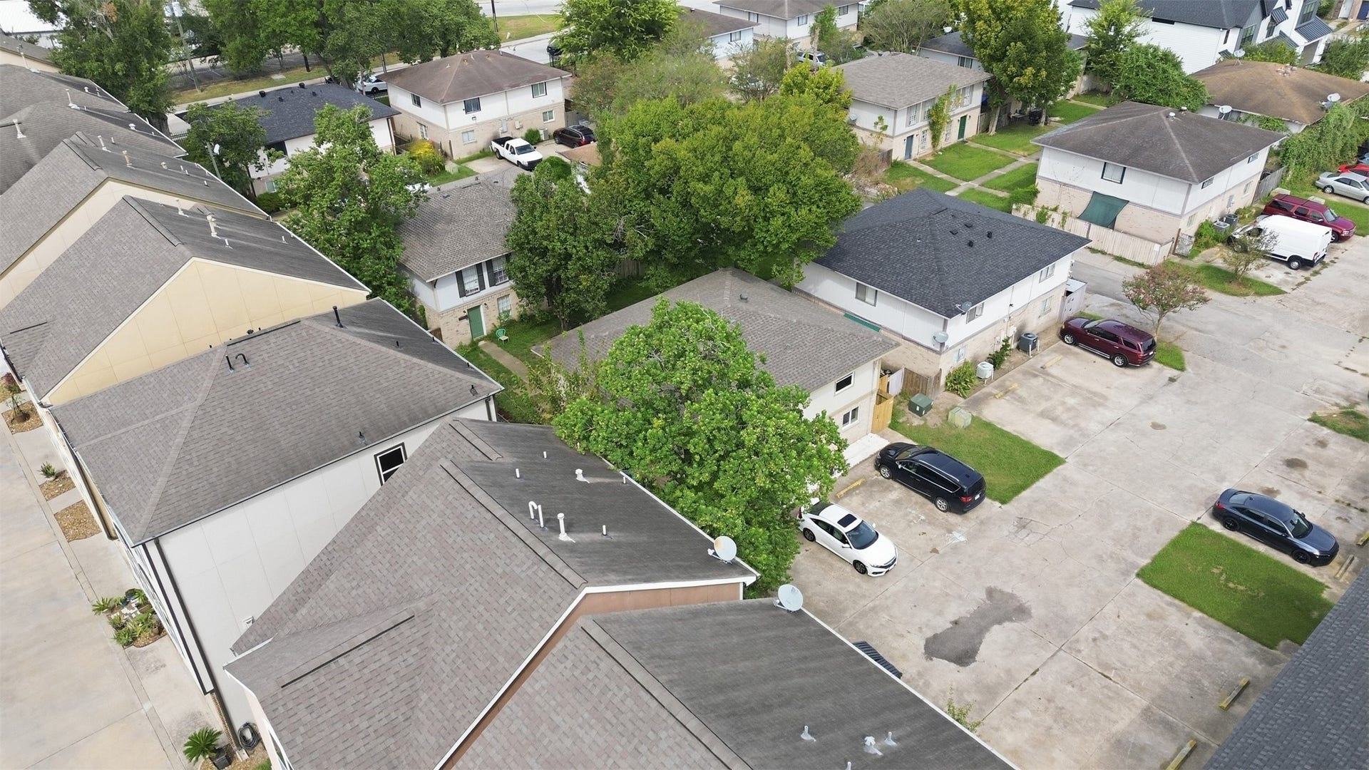1936 Upland Drive, Houston, TX 77043 Charming neighborhood with well-maintained townhomes and lush greenery, offering ample parking and a peaceful residential setting.