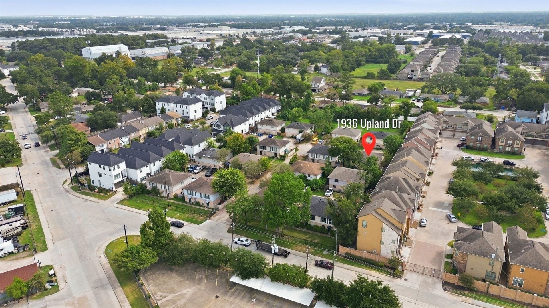1936 Upland Drive, Houston, TX 77043 Charming home located in a vibrant neighborhood, surrounded by lush greenery and modern townhouses, offering easy access to local amenities.