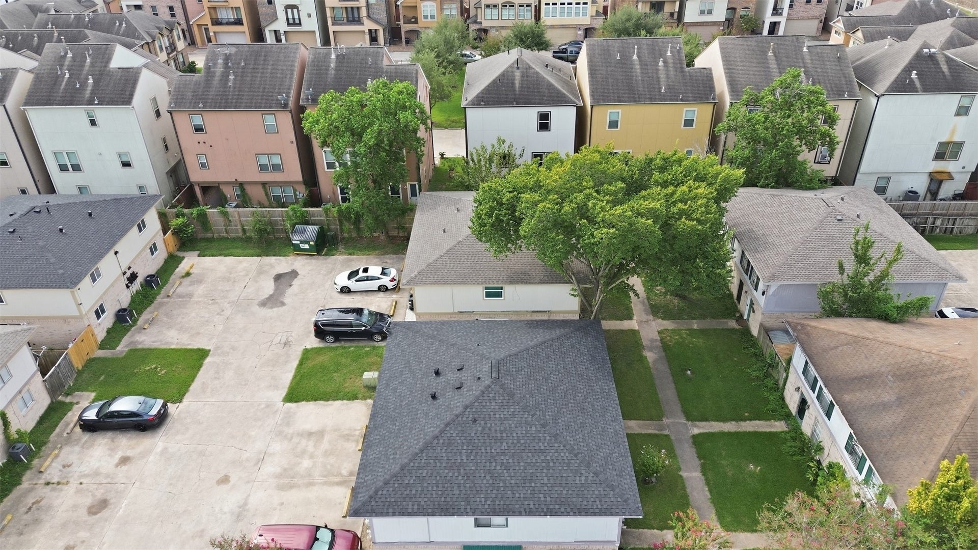 1936 Upland Drive, Houston, TX 77043 Charming neighborhood view showcasing a mix of cozy homes and lush greenery, offering a serene residential atmosphere with convenient parking.