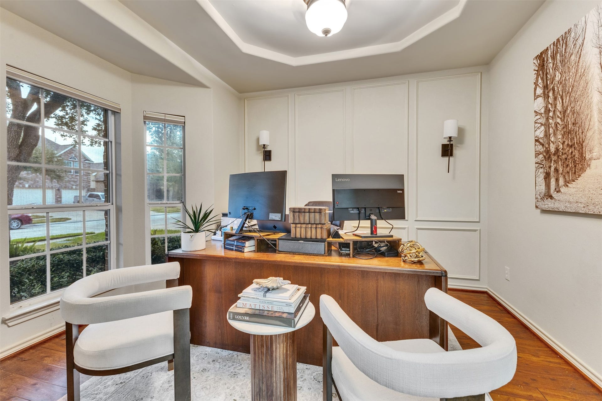 Work from home in style! Dedicated office with beautiful wood floors, decorative wall molding, and abundant natural light.