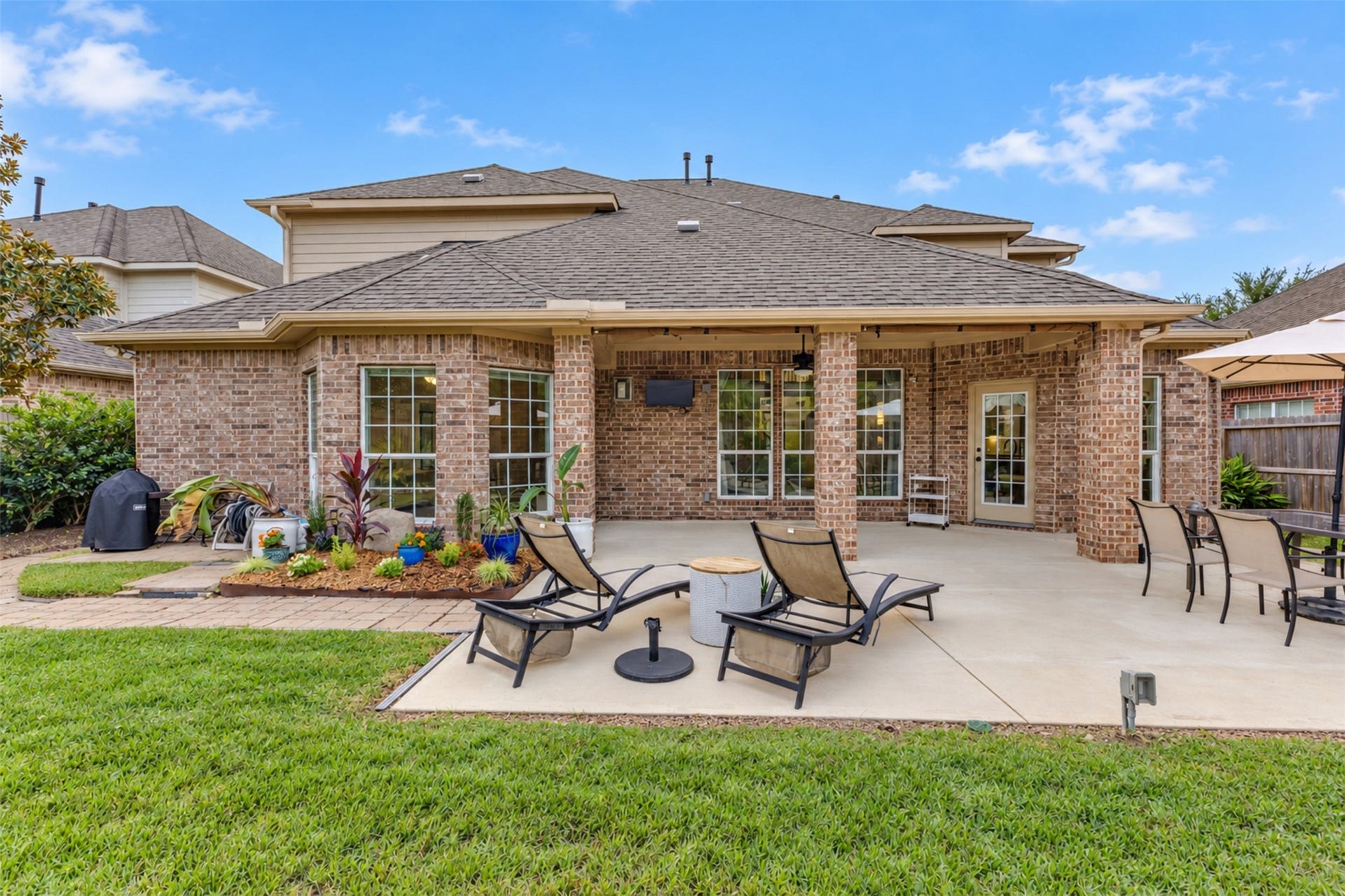 Enjoy the generous covered patio with ceiling fans, outdoor TV, and multiple seating areas.