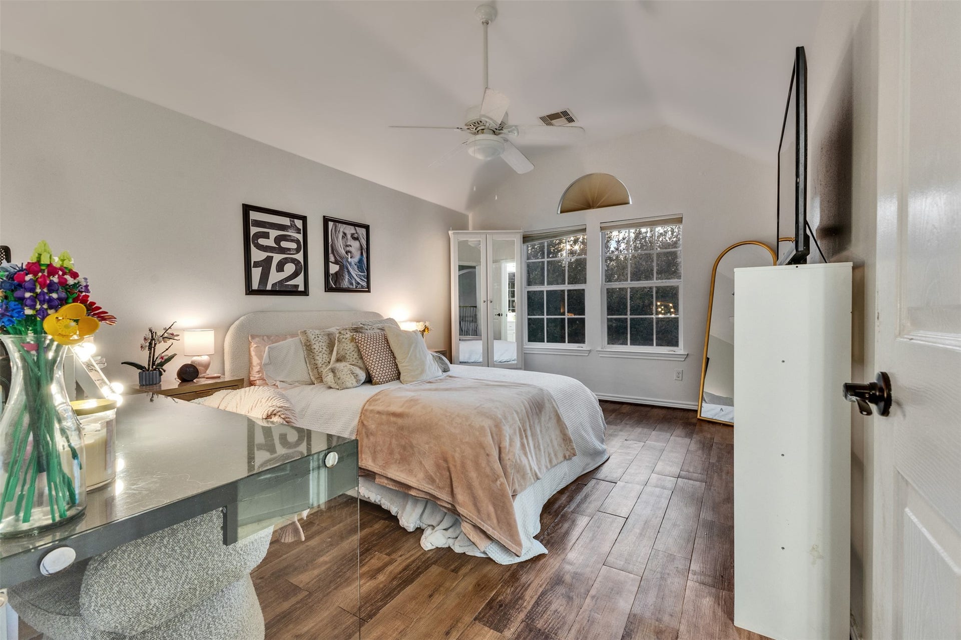 Bedroom 2: A bright, inviting bedroom with vaulted ceilings, beautiful flooring, and plenty of natural light. A comfortable space to relax and recharge.
