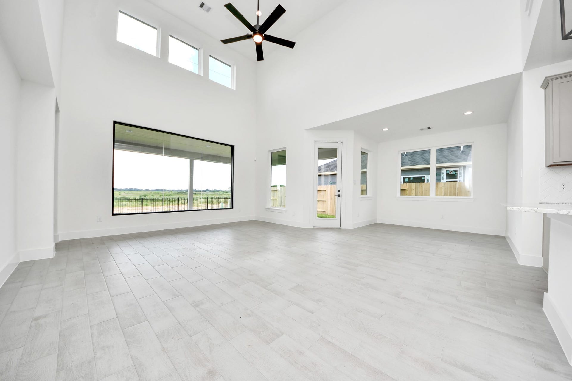 5914 Fox Peak Lane, Richmond, TX 77469 Gather the family and guests together in your lovely living room! Featuring soaring high ceilings, recessed lighting, ceiling fan, custom paint, gorgeous floors, and large windows that provide plenty of natural lighting throughout the day. Sample photo of completed home with similar floor plan. Actual colors and selections may vary.
