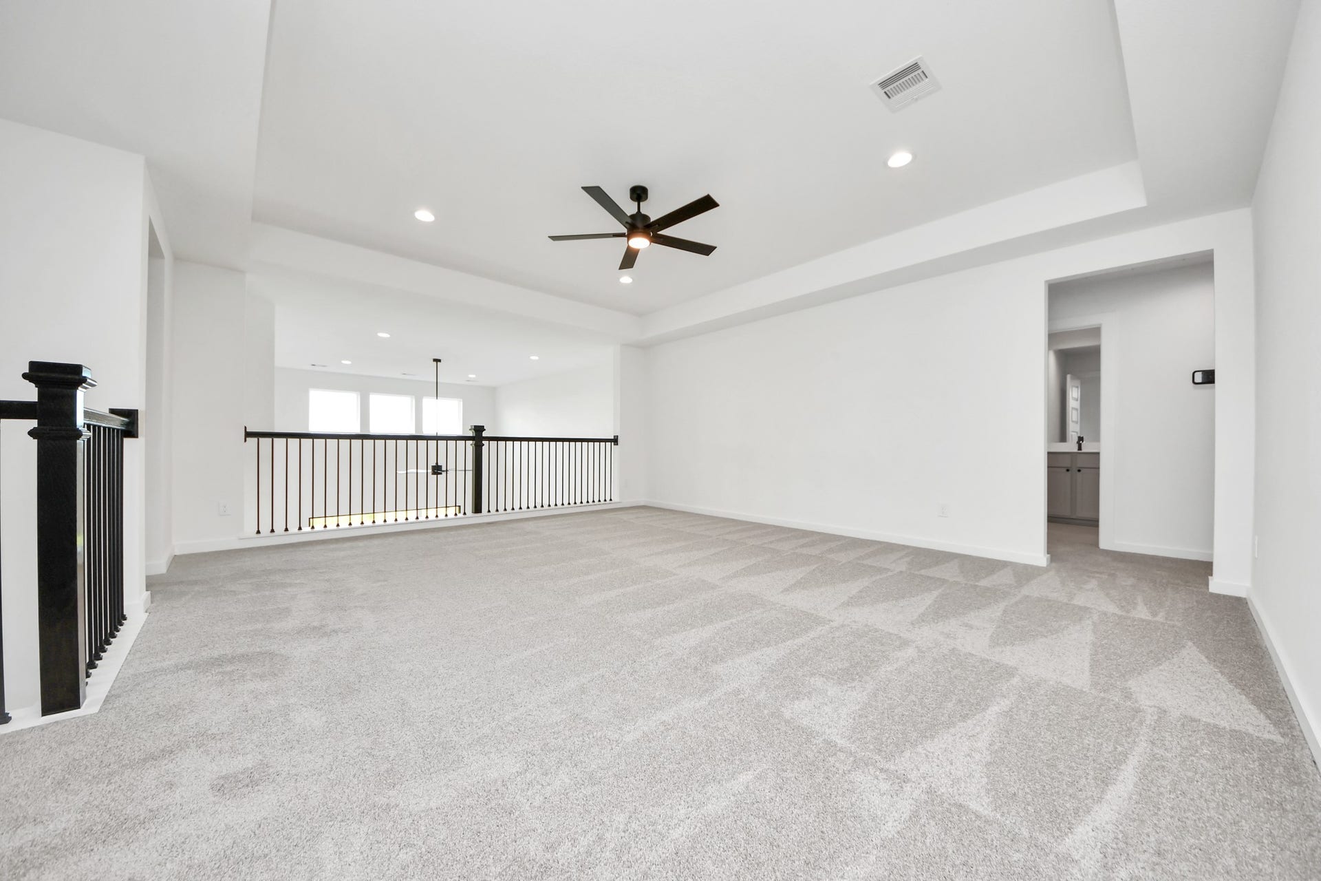 5914 Fox Peak Lane, Richmond, TX 77469 Come upstairs and enjoy a day of leisure in this fabulous game room! This is the perfect hangout spot or adult game room! Features plush carpet, high ceilings, custom paint and windows for plenty of natural light. Sample photo of completed home with similar floor plan. Actual colors and selections may vary.