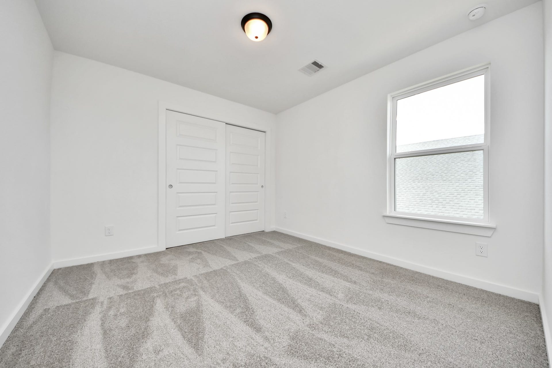 5914 Fox Peak Lane, Richmond, TX 77469 Secondary bedroom features plush carpeting, large windows that let in plenty of natural light, bright paint, and spacious closets. Sample photo of completed home with similar floor plan. Actual colors and selections may vary.