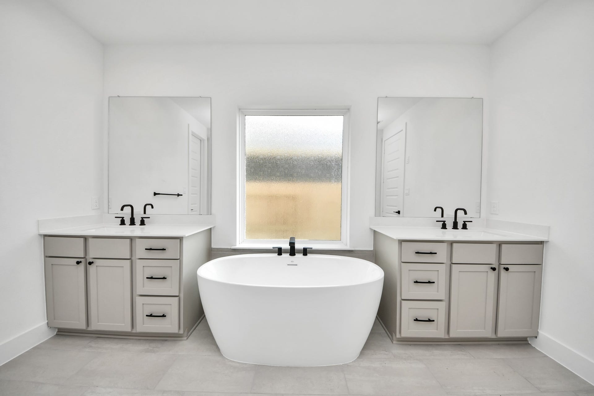 5914 Fox Peak Lane, Richmond, TX 77469 Indulge in a spa-like retreat within the confines of this primary bathroom. Delight in a spacious walk-in shower enveloped in stylish tile surround, unwind in a separate garden tub adorned with custom detailing. Sample photo of completed home with similar floor plan. Actual colors and selections may vary.