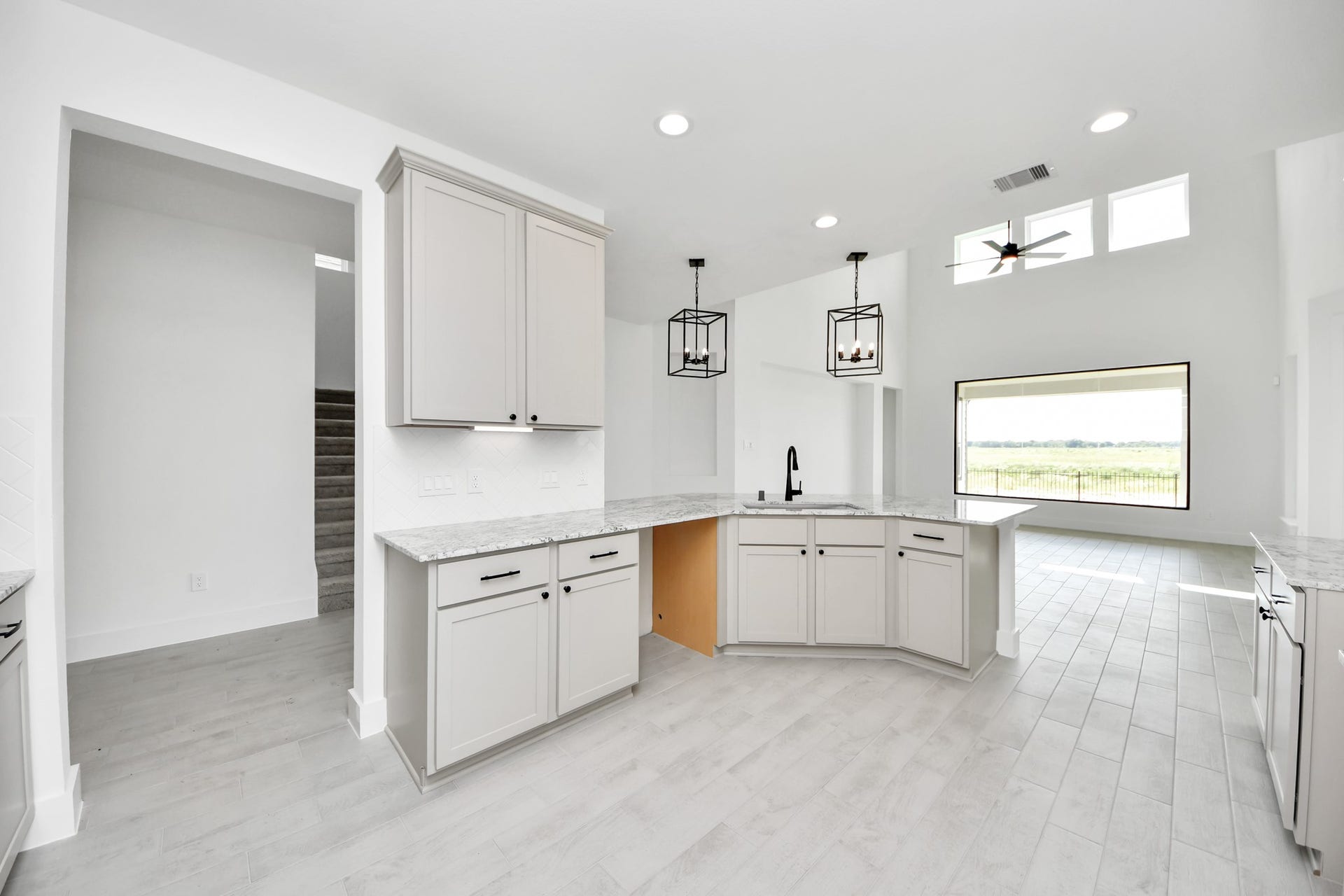 5914 Fox Peak Lane, Richmond, TX 77469 The extended counter area adds both practicality and style, making meal preparation a breeze. Every detail is thoughtfully designed to enhance the kitchen's functionality and aesthetic appeal. Sample photo of completed home with similar floor plan. Actual colors and selections may vary.