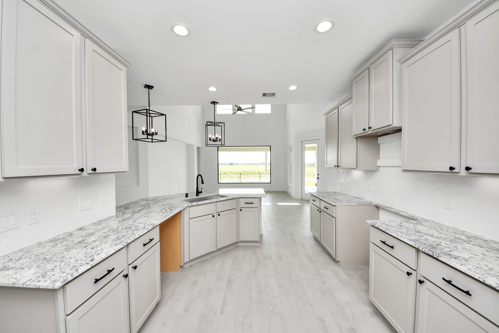 5914 Fox Peak Lane, Richmond, TX 77469 The kitchen is a culinary haven, featuring granite countertops, a tile backsplash, stainless steel appliances, 42 upper cabinets, and undercabinet lighting. Sample photo of completed home with similar floor plan. Actual colors and selections may vary.