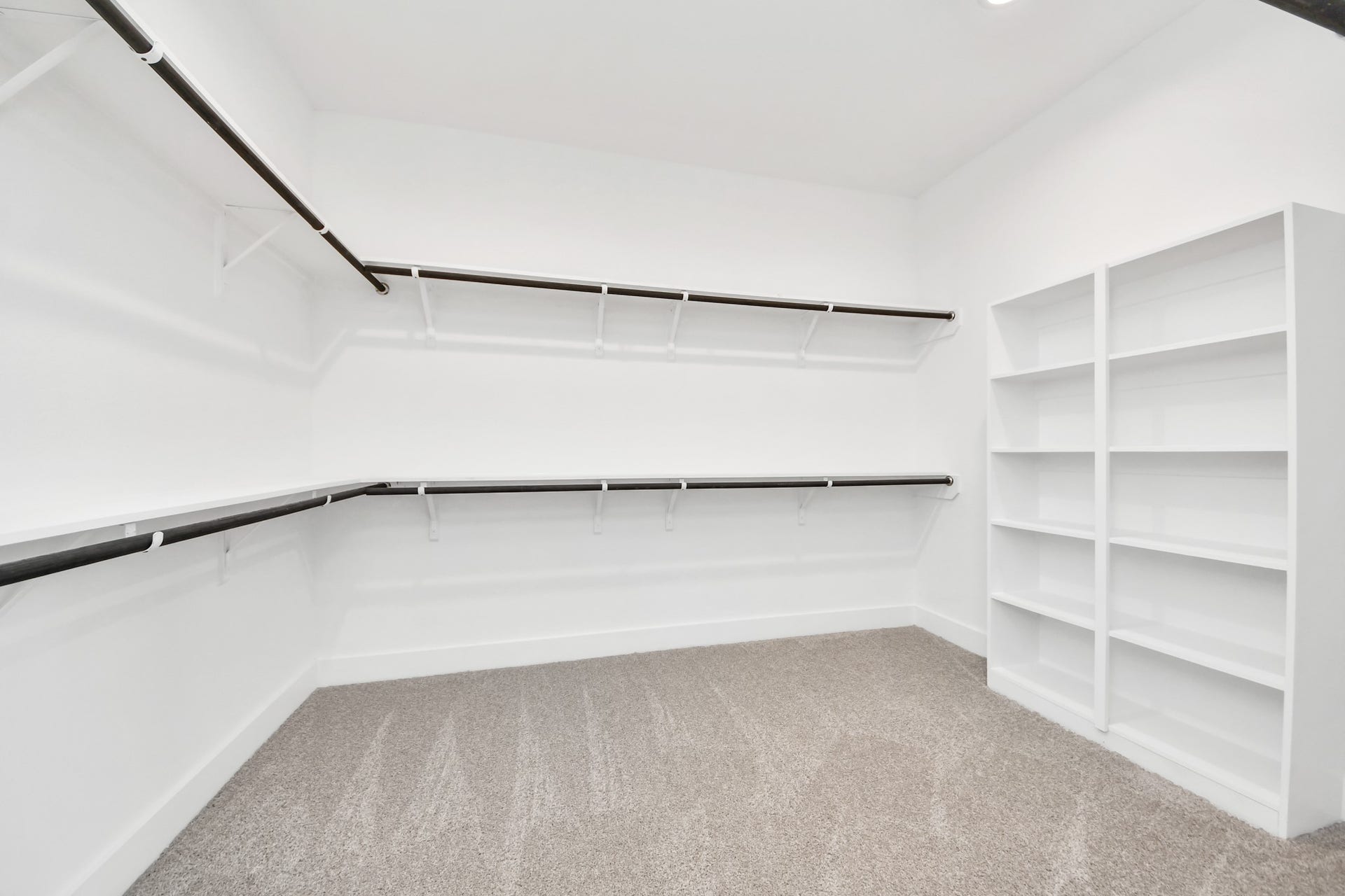 5914 Fox Peak Lane, Richmond, TX 77469 Walk-in closet that epitomizes luxury and practicality. This generously sized space features built-in shelving, offering abundant room for impeccable organization. High ceilings and recessed lighting create a bright and welcoming ambiance. Sample photo of completed home with similar floor plan. Actual colors and selections may vary.