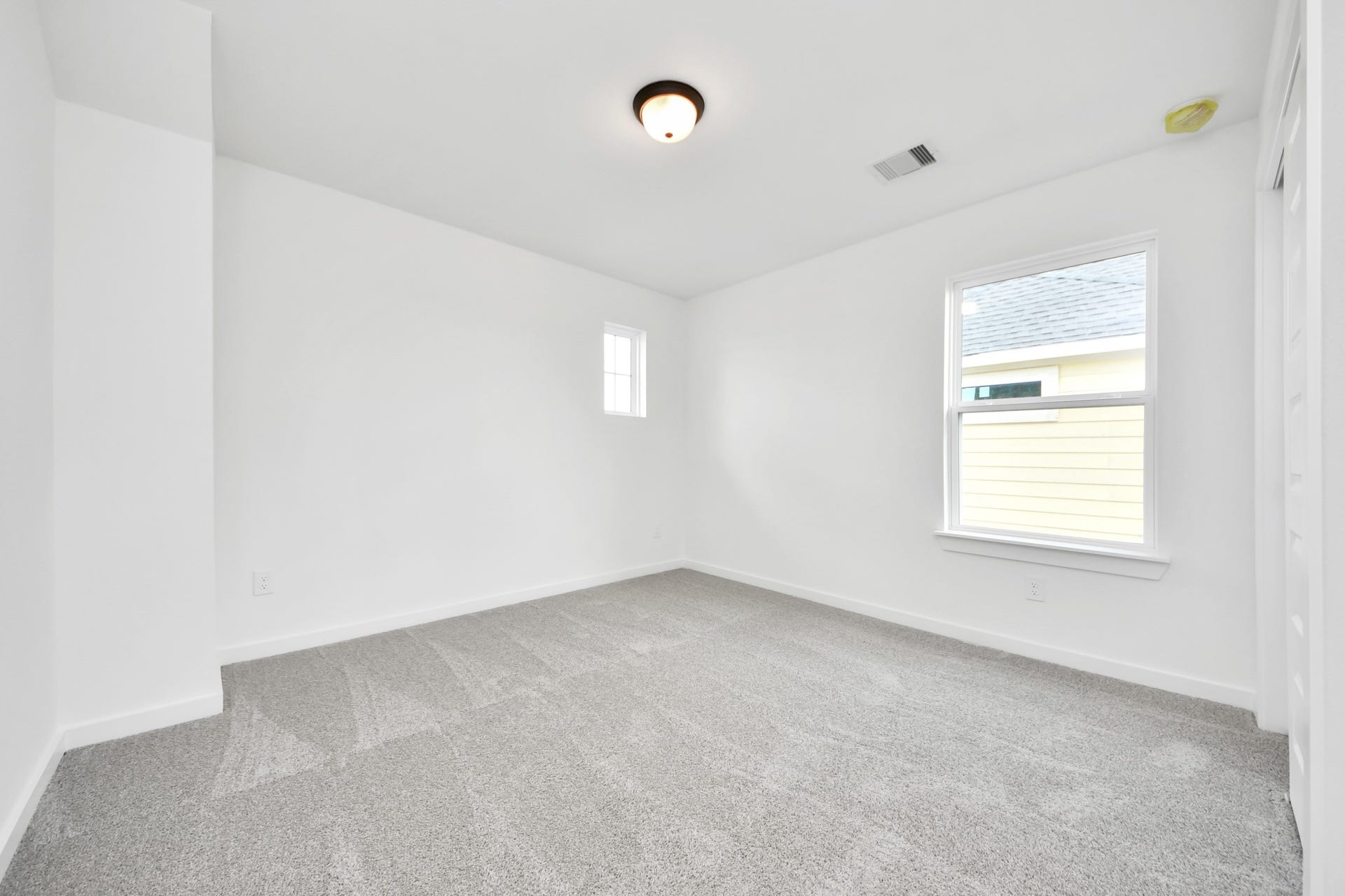 5914 Fox Peak Lane, Richmond, TX 77469 Secondary bedroom features plush carpeting, large windows that let in plenty of natural light, bright paint, and spacious closets. Sample photo of completed home with similar floor plan. Actual colors and selections may vary.