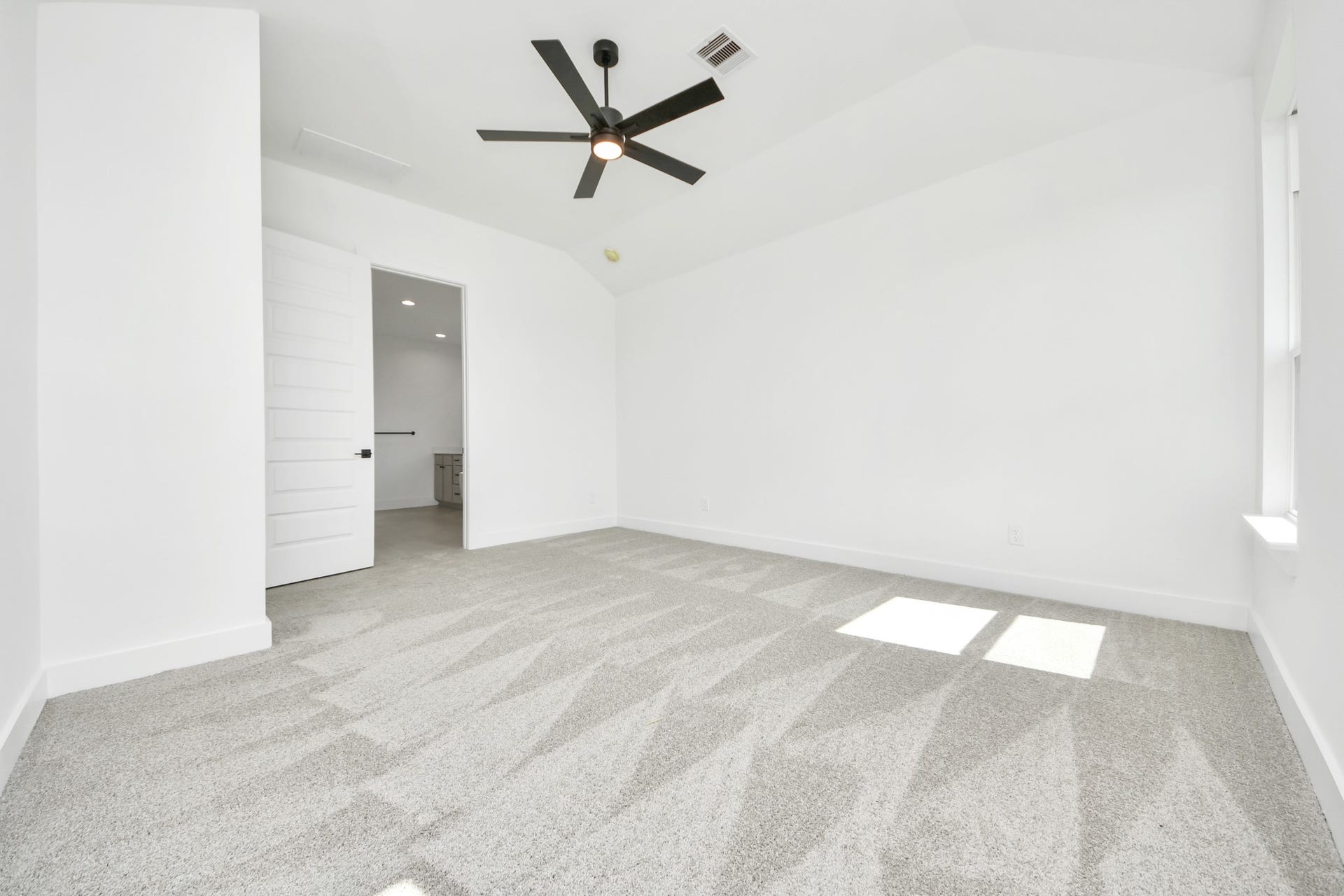 5914 Fox Peak Lane, Richmond, TX 77469 Escape to tranquility in this spacious primary room, adorned with plush carpeting and bathed in the soothing hues of warm paint colors, creating a cozy retreat for relaxation. Sample photo of completed home with similar floor plan. Actual colors and selections may vary.
