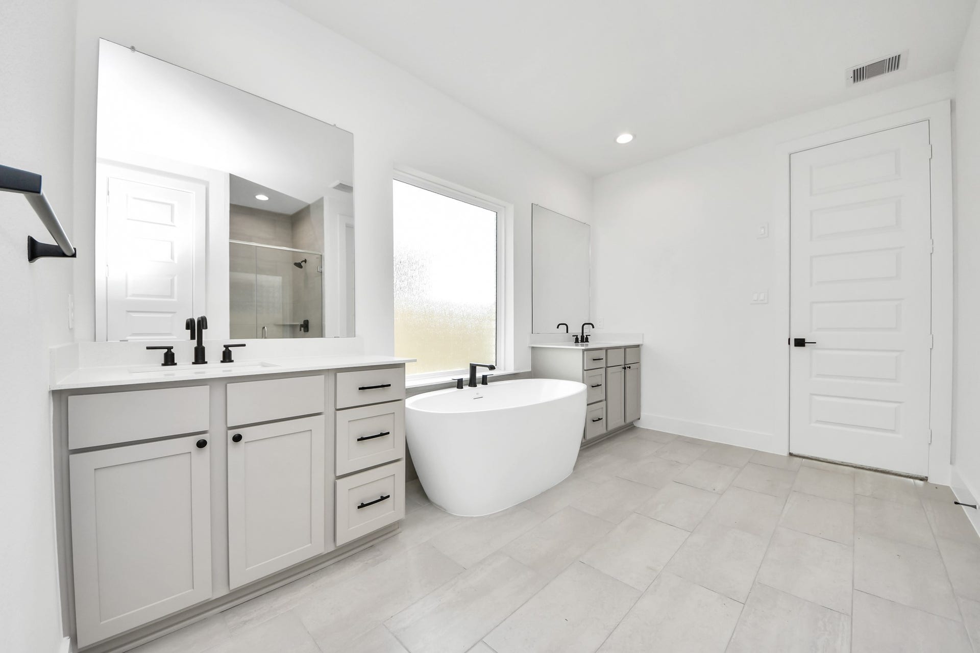 5914 Fox Peak Lane, Richmond, TX 77469 Elevate your daily routine at the elegant vanity, now equipped with double sinks, light countertops, modern hardware, and beautiful recessed lights. Sample photo of completed home with similar floor plan. Actual colors and selections may vary.