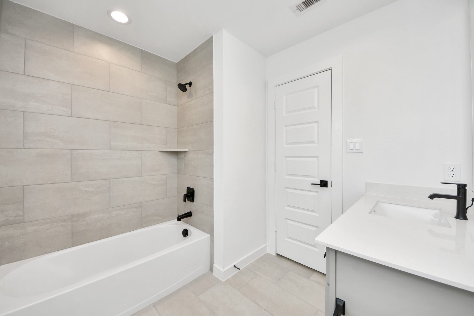 5914 Fox Peak Lane, Richmond, TX 77469 Secondary bath features tile flooring, bath/shower combo with tile surround, light stained wood cabinets, beautiful light countertop. Sample photo of completed home with similar floor plan. Actual colors and selections may vary.
