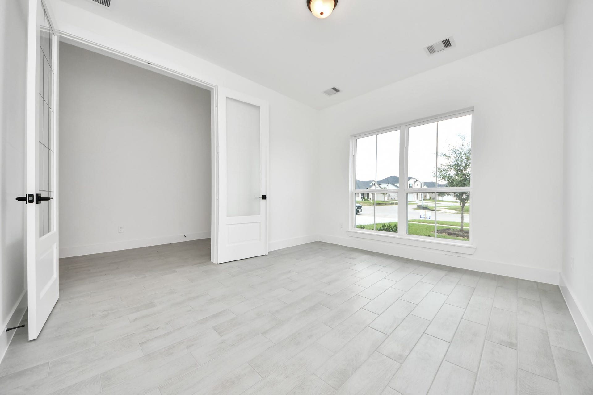 5914 Fox Peak Lane, Richmond, TX 77469 Step into the inviting home office, where elegant tile flooring adds a touch of freshness and comfort to the workspace. Natural light pours through the window, creating an inspiring environment for productivity and focus. Sample photo of completed home with similar floor plan. Actual colors and selections may vary.