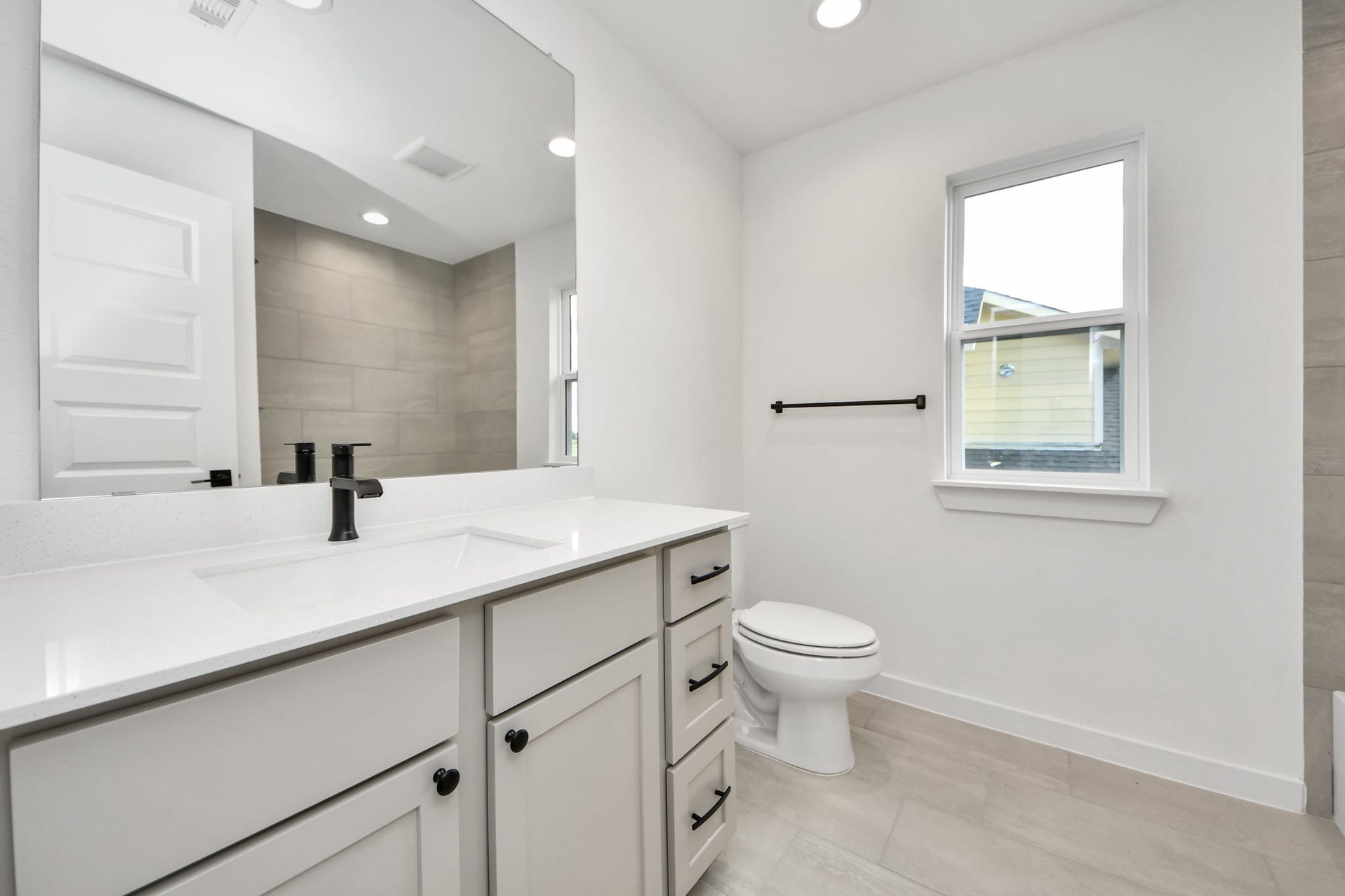 5914 Fox Peak Lane, Richmond, TX 77469 Secondary bath features tile flooring, bath/shower combo with tile surround, light stained wood cabinets, beautiful light countertop. Sample photo of completed home with similar floor plan. Actual colors and selections may vary.