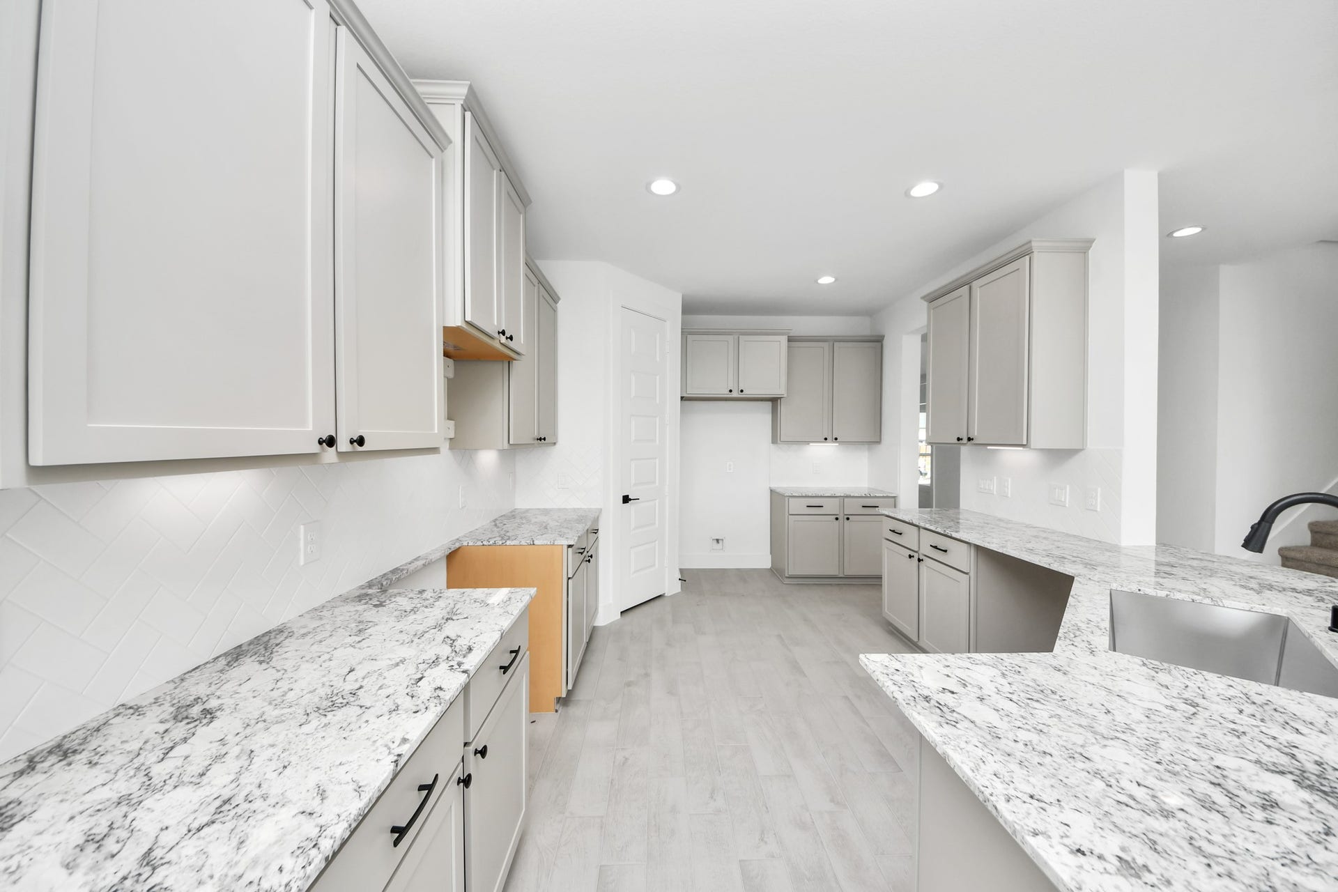 5914 Fox Peak Lane, Richmond, TX 77469 Discover another perspective of this stunning kitchen, generously appointed with an abundance of counter space. Sample photo of completed home with similar floor plan. Actual colors and selections may vary.