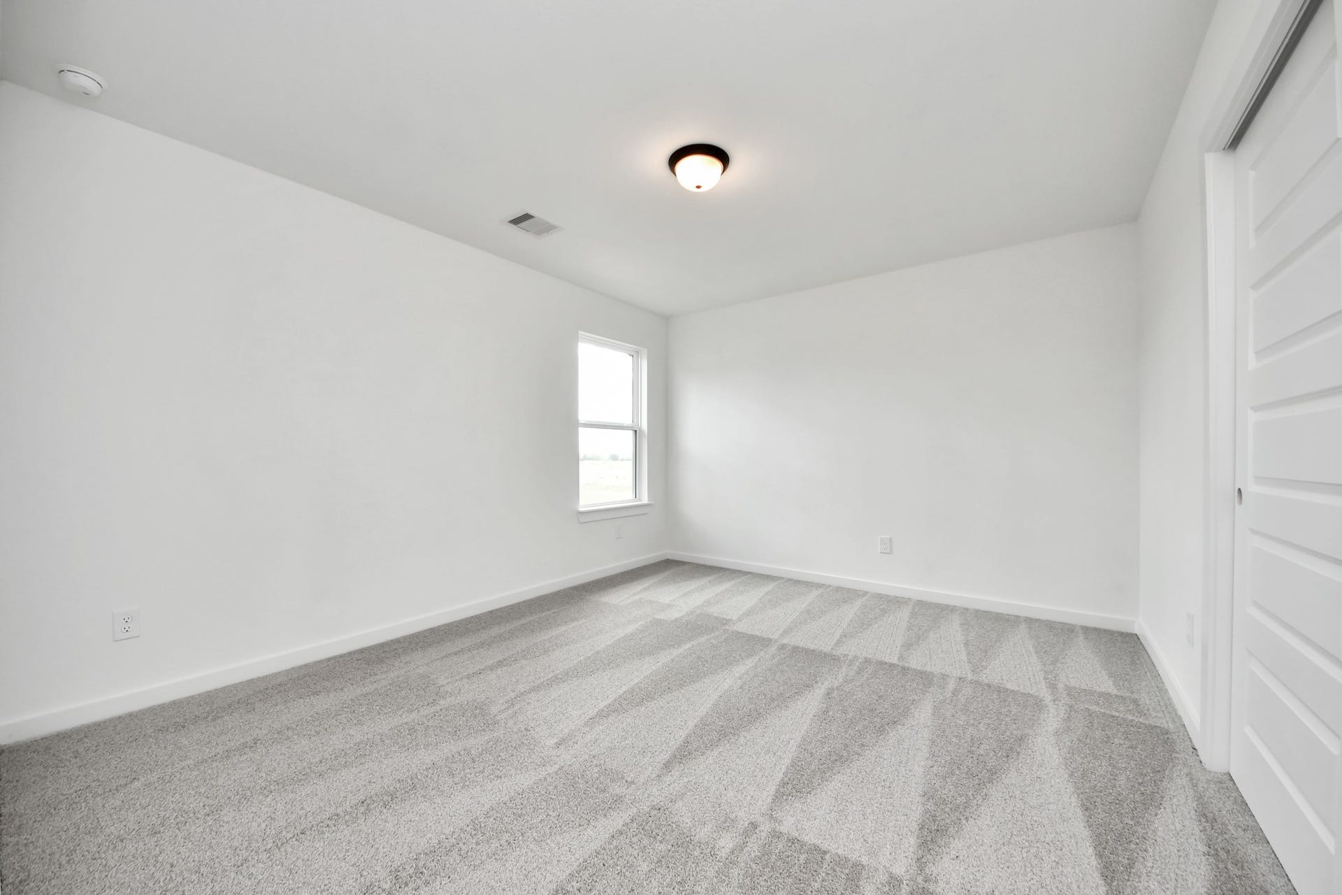 5914 Fox Peak Lane, Richmond, TX 77469 Secondary bedroom features plush carpeting, large windows that let in plenty of natural light, bright paint, and spacious closets. Sample photo of completed home with similar floor plan. Actual colors and selections may vary.