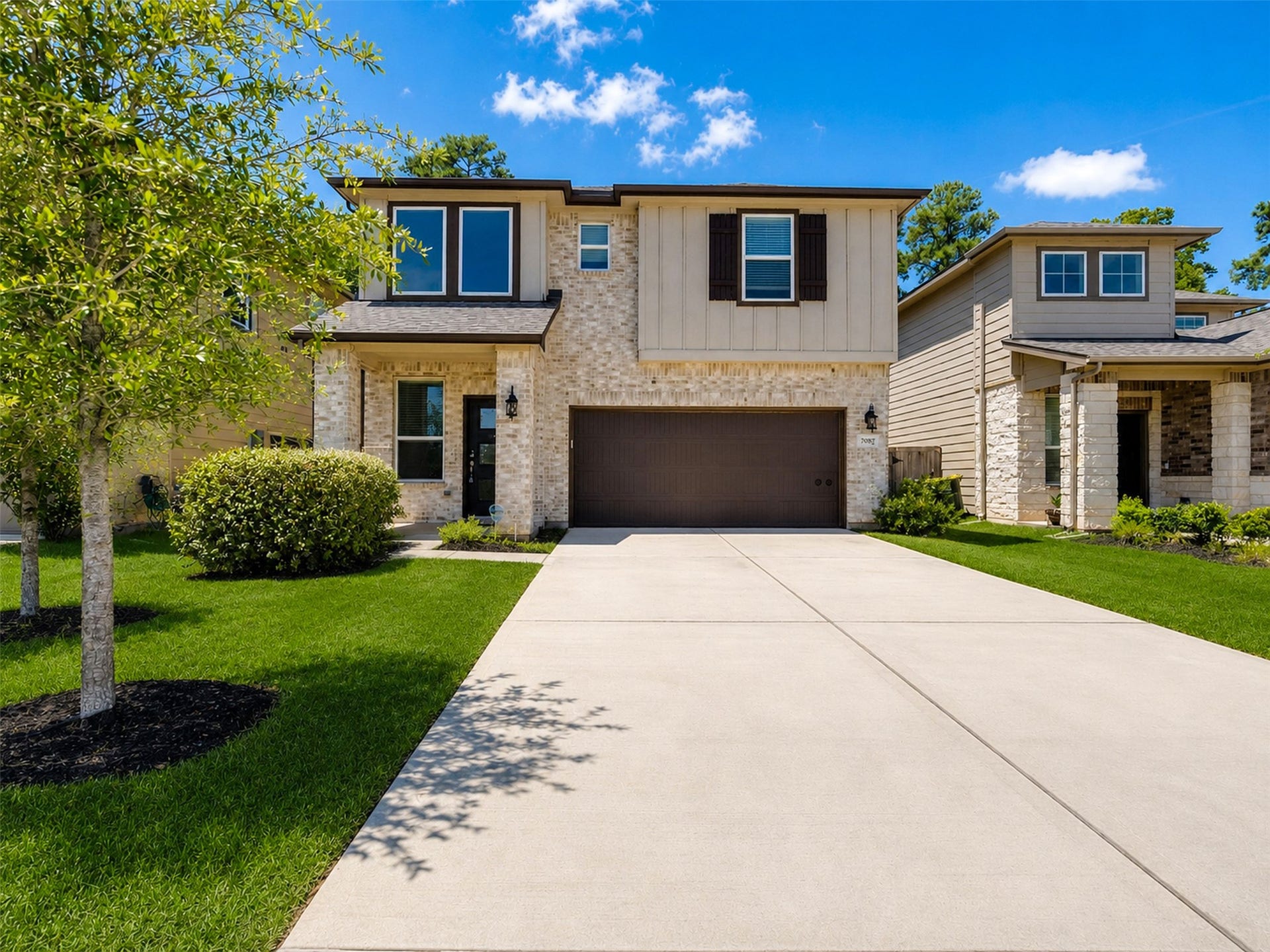Beautiful two-story home with modern exterior and inviting covered front entry.