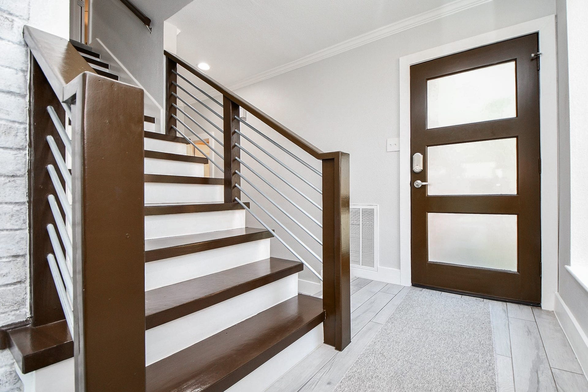811 Bayou River Drive, Houston, TX 77079 The contemporary front door has frosted glass panels and a keyless smart lock.