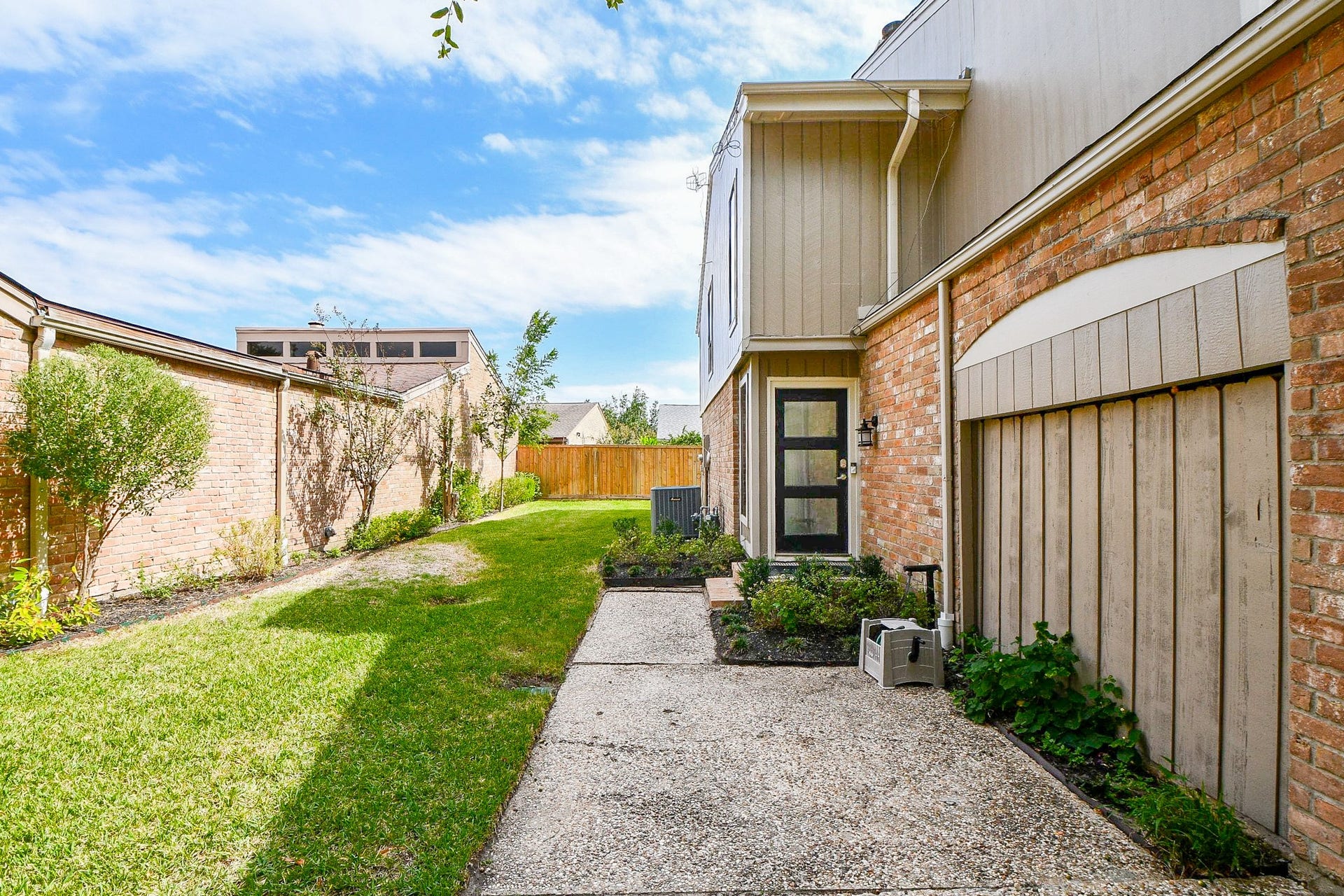811 Bayou River Drive, Houston, TX 77079 A mature shade tree anchors the front yard, which has a cedar privacy fence.