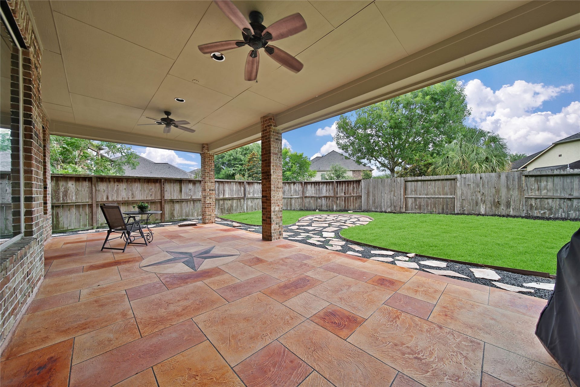 27707 Lakeway Trail Lane, Fulshear, TX 77441 WOW! Expansive covered patio features two fans to keep the breeze circulating, creating the perfect outdoor space for relaxing and entertaining. A walkway along the left side of the home Now this is a patio! The expaprovides a nice buffer from neighbors while adding to the spacious feel and privacy of the backyard. Exterior Gas Stub allows for future outdoor kitchen.