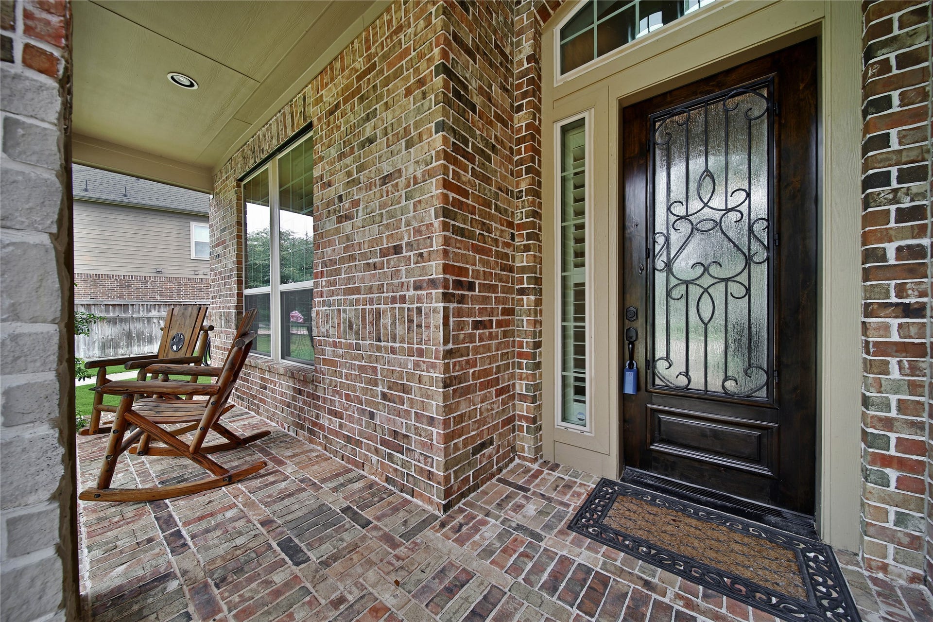 27707 Lakeway Trail Lane, Fulshear, TX 77441 The inviting front porch is the perfect place to start your day with a cup of coffee while taking in the scenic lake views.