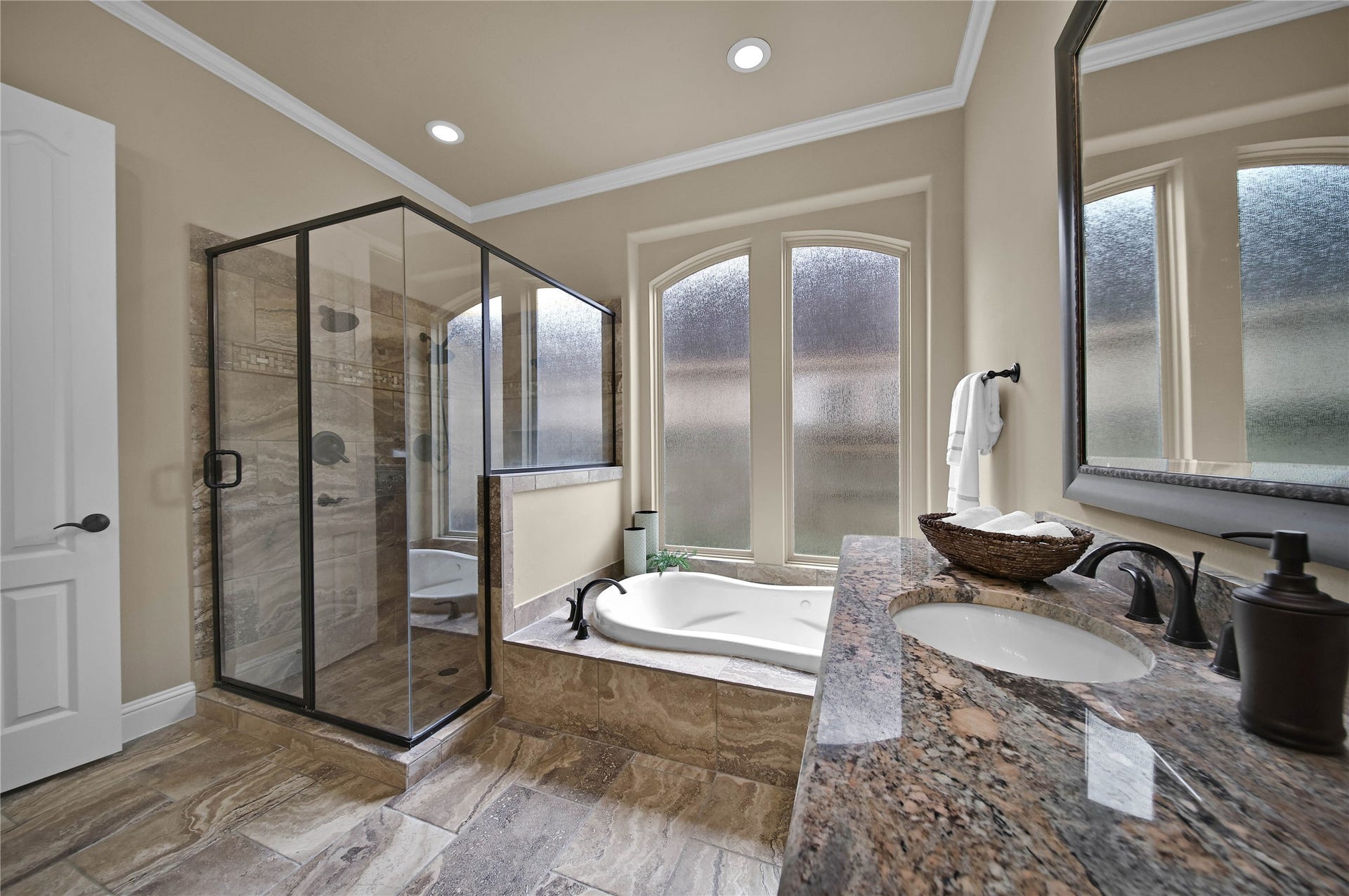 27707 Lakeway Trail Lane, Fulshear, TX 77441 The primary bath offers the perfect place to relax and rejuvenate with a luxurious jetted tub and a separate shower with dual shower heads designed for comfort and convenience.