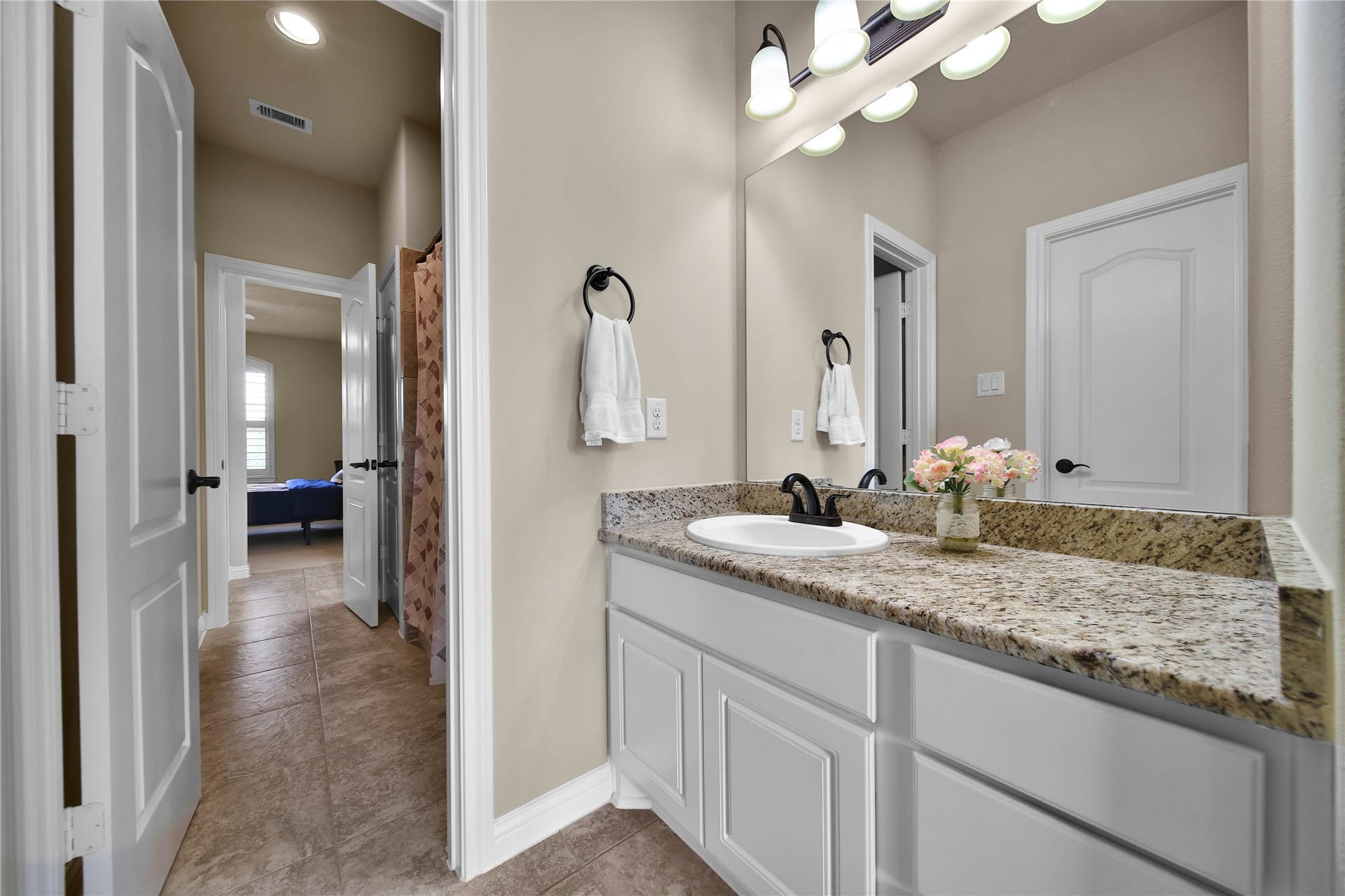 27707 Lakeway Trail Lane, Fulshear, TX 77441 Bedrooms 2 and 3 each feature a private vanity area and are thoughtfully connected by a shared Jack-and-Jill style bathroom for added convenience and functionality.