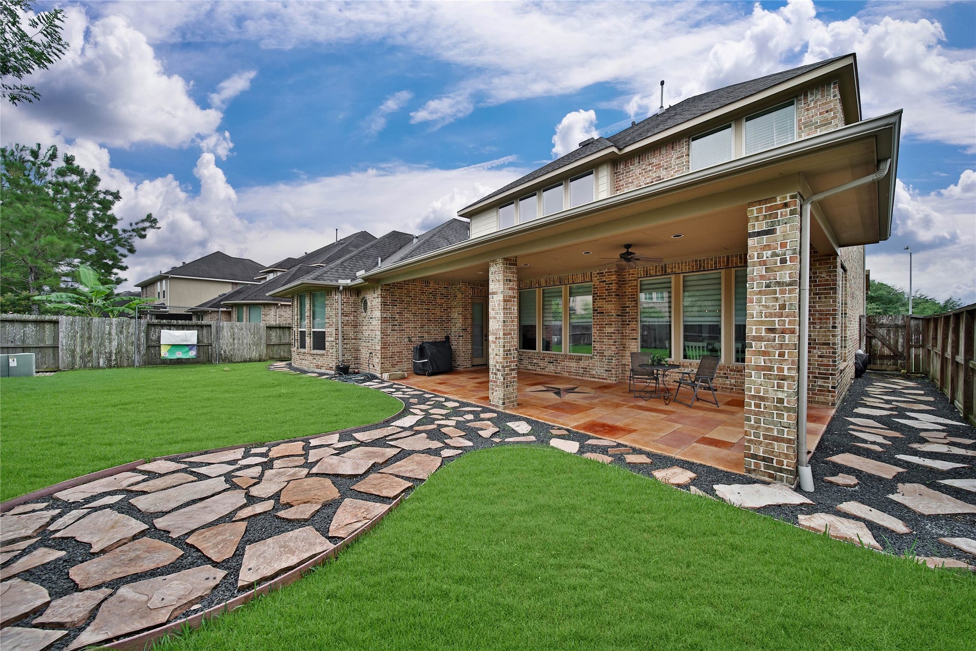 27707 Lakeway Trail Lane, Fulshear, TX 77441 **Note: Seller is happy to remove flagstone/ rocks and resod the backyard with grass if a buyer prefers! Flagstone and rock create a charming walkway along the side of the home and a designated seating area in the backyard. These features add character and functionality while remaining flexible and easily removable should you choose to redesign the outdoor space in the future.
