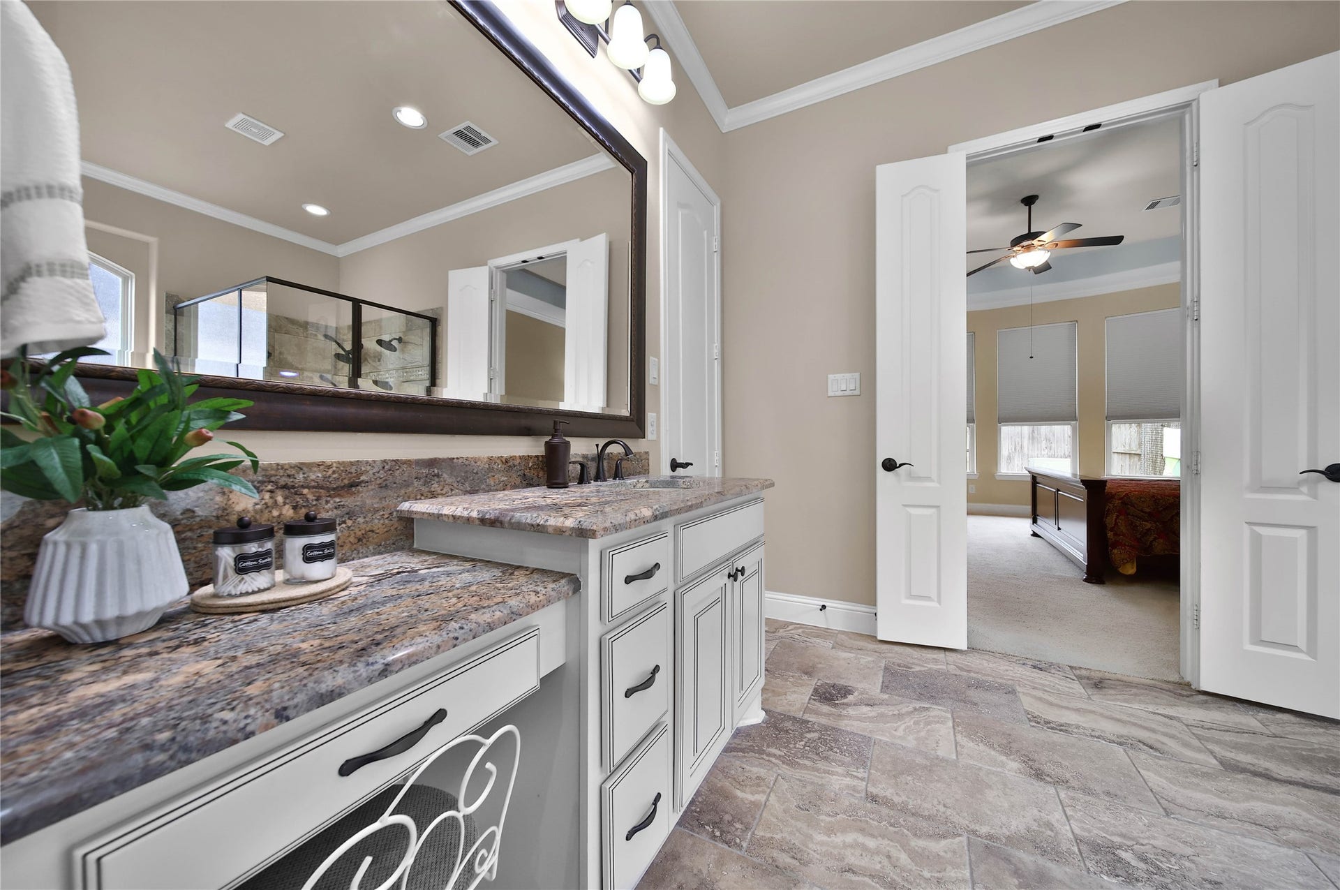 27707 Lakeway Trail Lane, Fulshear, TX 77441 The primary bath offers dual sinks and a convenient sit-down vanity area, providing both functionality and a touch of luxury for your daily routine.