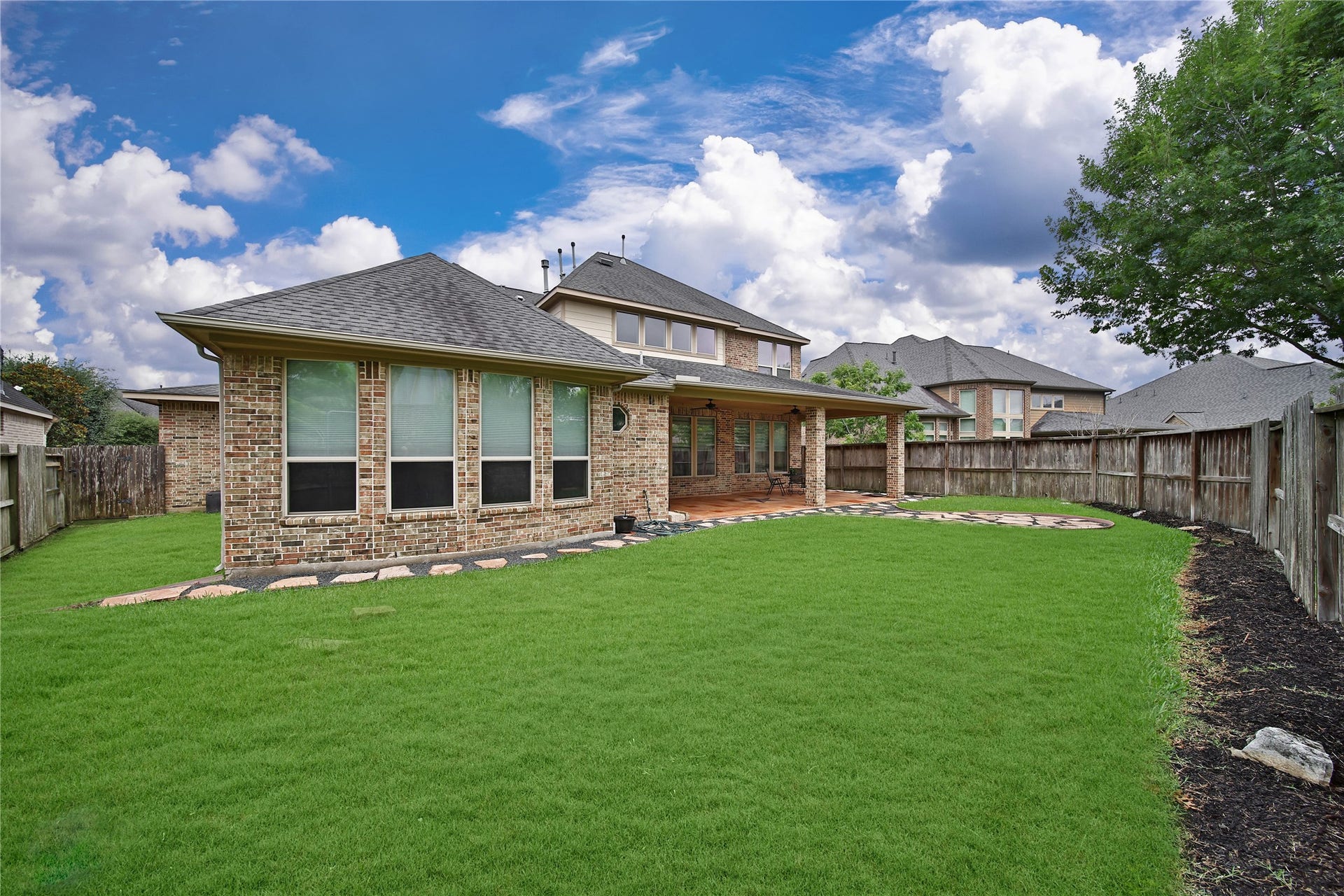 27707 Lakeway Trail Lane, Fulshear, TX 77441 This pool-sized backyard offers plenty of space to create your dream outdoor oasis, whether you envision a pool, play area, or a custom entertaining space. **Note: Seller is happy to remove flagstone/ rocks and resod the backyard with grass if a buyer prefers! **