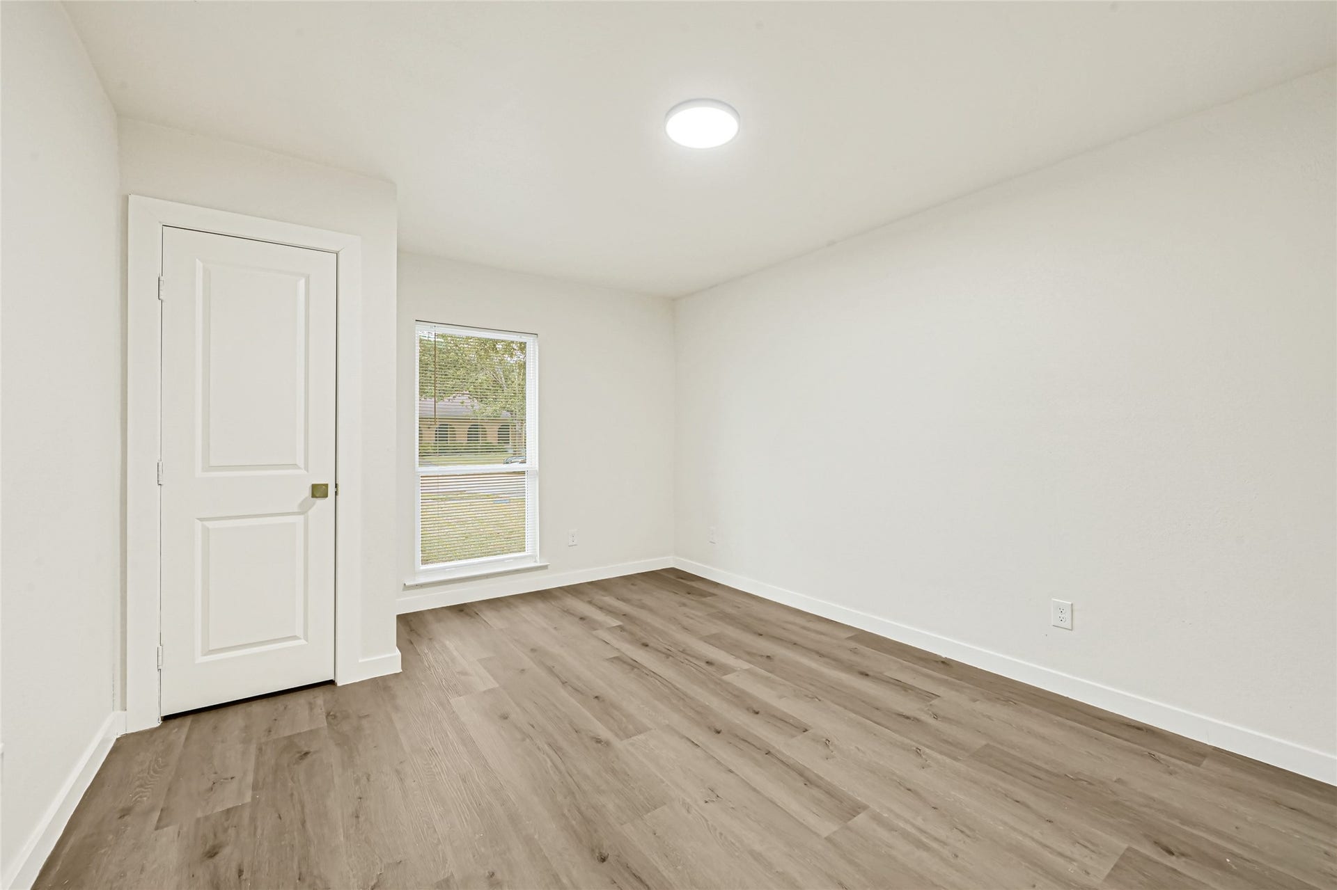 11102 Sagecanyon Drive, Houston, TX 77089 Bright second bedroom with updated flooring and modern finishes.