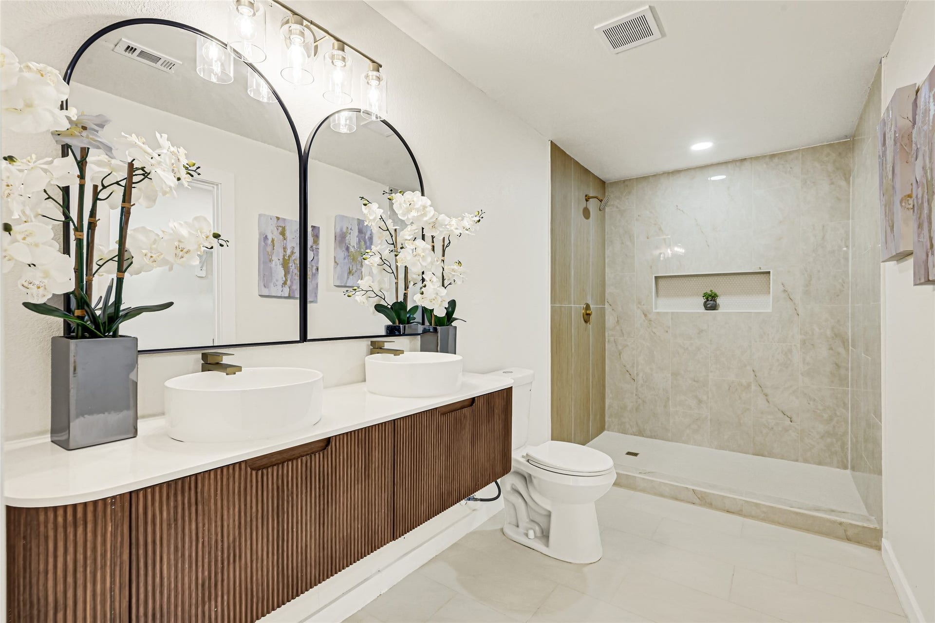 11102 Sagecanyon Drive, Houston, TX 77089 Spa-inspired primary bathroom featuring dual vanities, elegant brushed gold fixtures, and a beautifully tiled walk-in shower