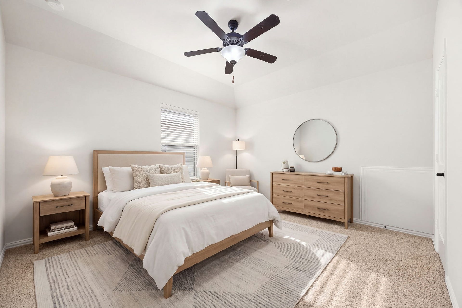 9931 Hutton Park Drive, Katy, TX 77494 This beautifully proportioned room features a classic recessed tray ceiling with raised ceilings and a central fan. Bright, neutral paint balances the soft flooring, while a large window welcomes plenty of natural light, making it a perfect space for family or guests.