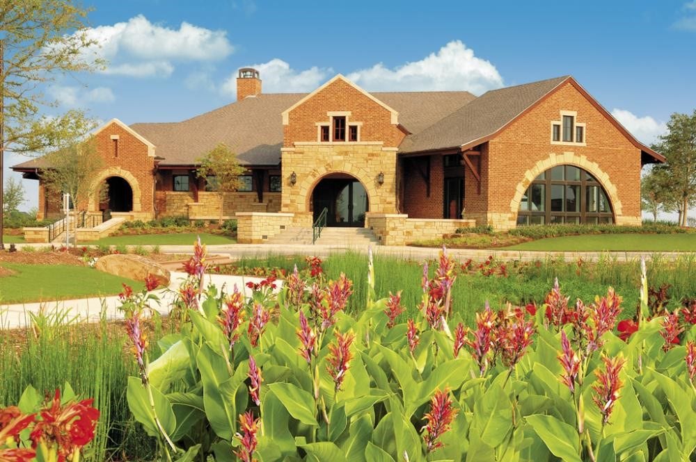 9931 Hutton Park Drive, Katy, TX 77494 This beautiful image highlights the stunning exterior of the Cinco Ranch Lake House, located at 25202 Springwood Lake Dr in Katy, TX. Serving as the heart of the neighborhood, this 6,000 sq ft community center is surrounded by lush landscaping and picturesque flowers, emphasizing the master-planned luxury and resort-style lifestyle that residents enjoy daily.