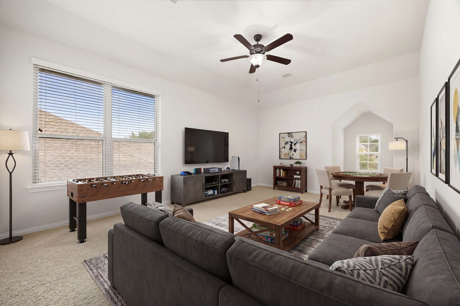 9931 Hutton Park Drive, Katy, TX 77494 This versatile gameroom features high ceilings, a central ceiling fan, and raised ceilings that frames the room. Large windows fill the area with natural light, while an elegant arched wall cutout keeps the space feeling connected to the rest of the upper level, offering the perfect footprint for a media center, play area, or secondary lounge.