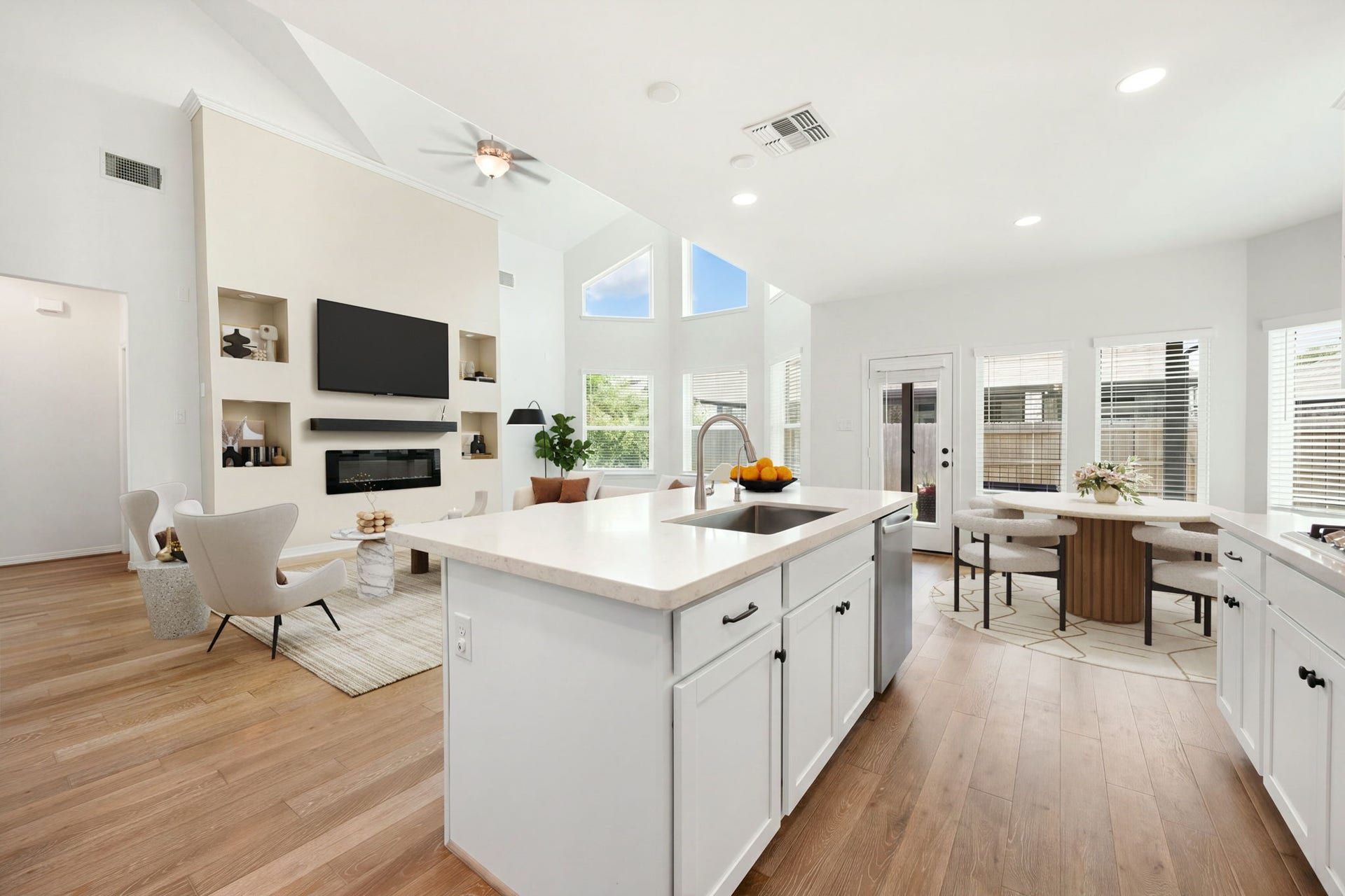 30715 Parkside Passage Drive, Fulshear, TX 77441 This sweeping angle emphasizes the expansive, light-filled layout connecting the kitchen island directly to the majestic great room and casual dining area. The kitchen island is the perfect platform for open-concept entertaining. *Virtually Staged
