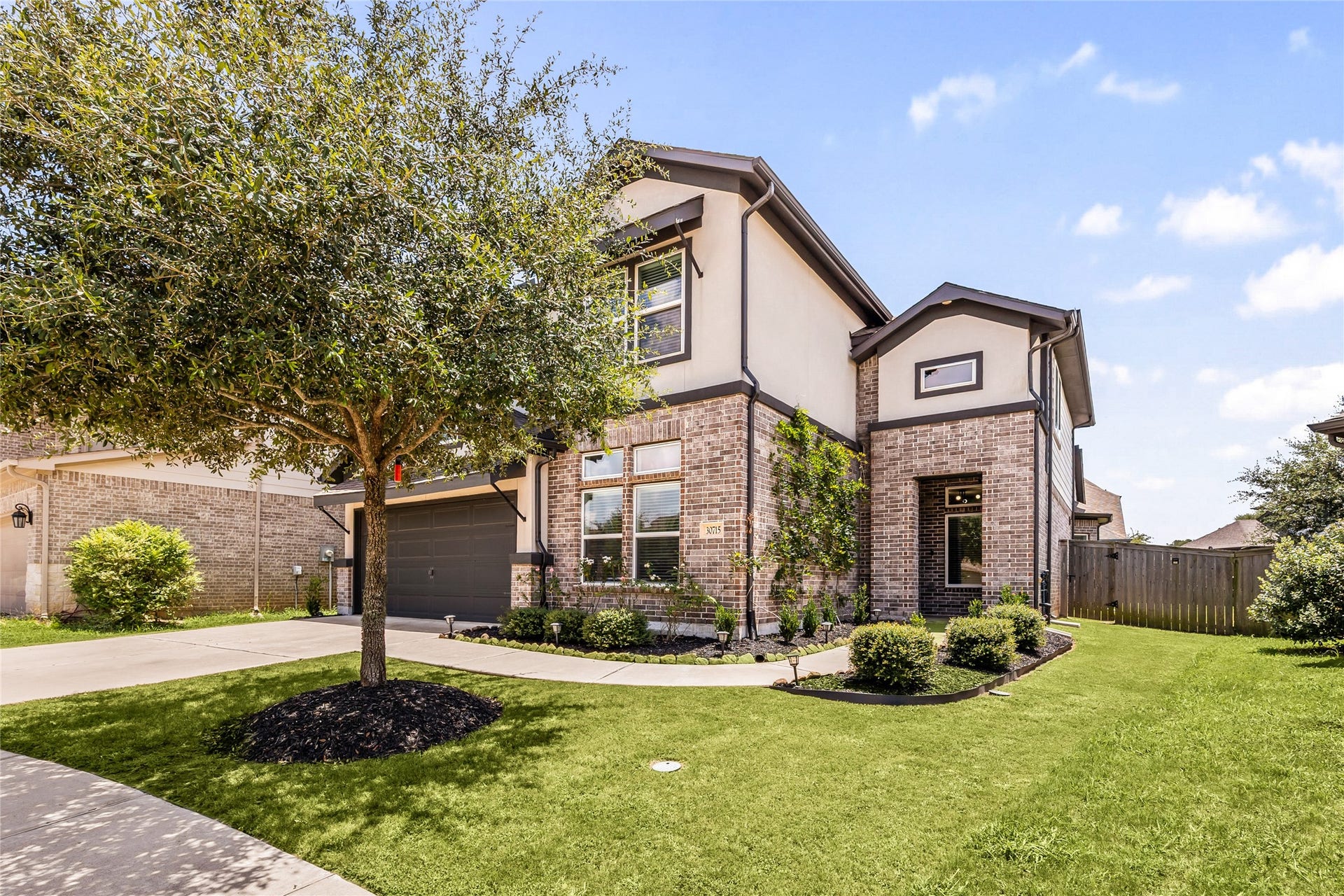 30715 Parkside Passage Drive, Fulshear, TX 77441 Welcome home to 30715 Parkside Passage Drive ocated on a quiet street in Fulbrook and zoned to LCISD! This stunning home has lovely curb appeal, a well-manicured lawn, beautiful landscaping, covered front porch, traditional style and a double wide driveway!