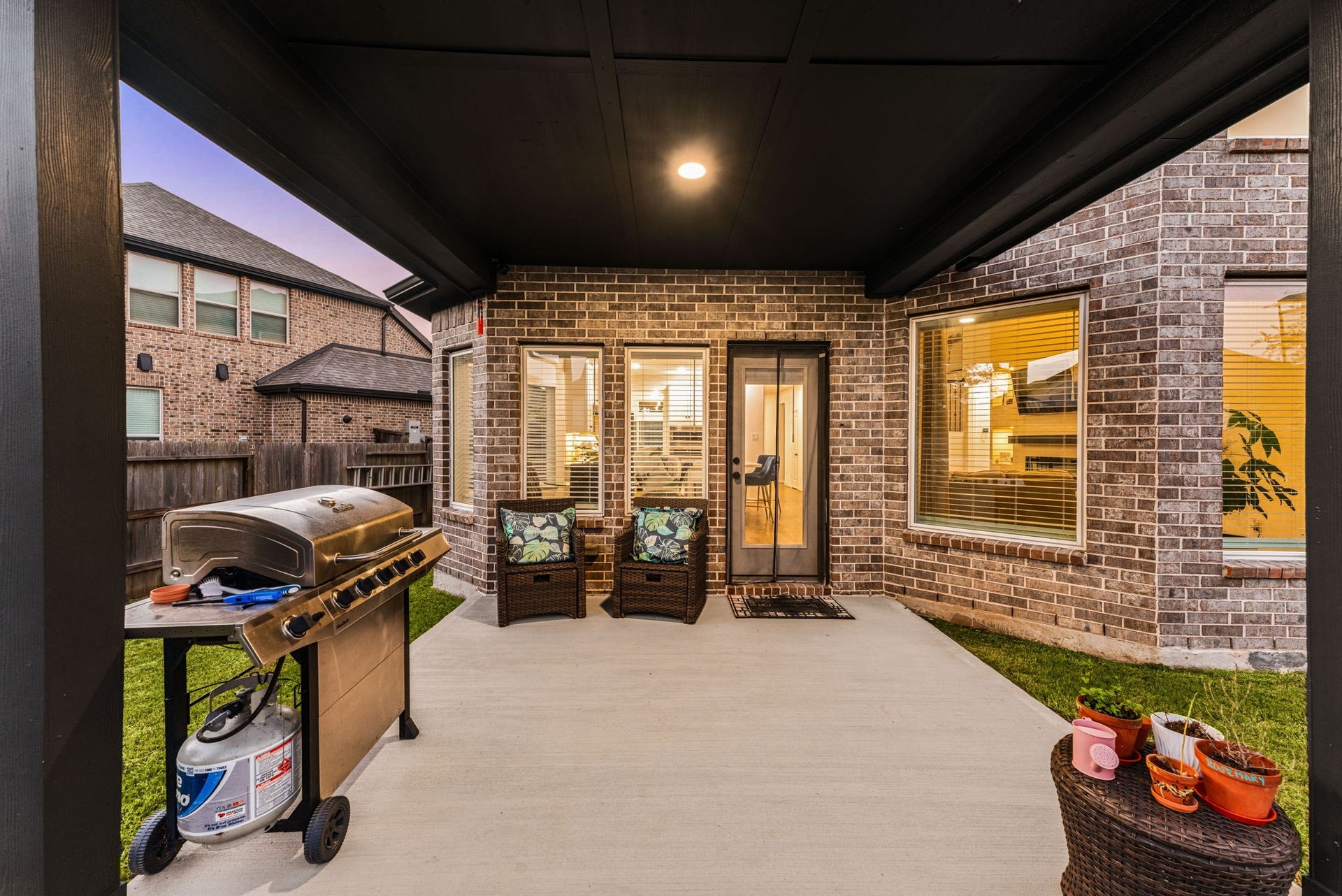 30715 Parkside Passage Drive, Fulshear, TX 77441 The deep and spacious covered back patio is perfect for year-round outdoor entertaining and relaxation.