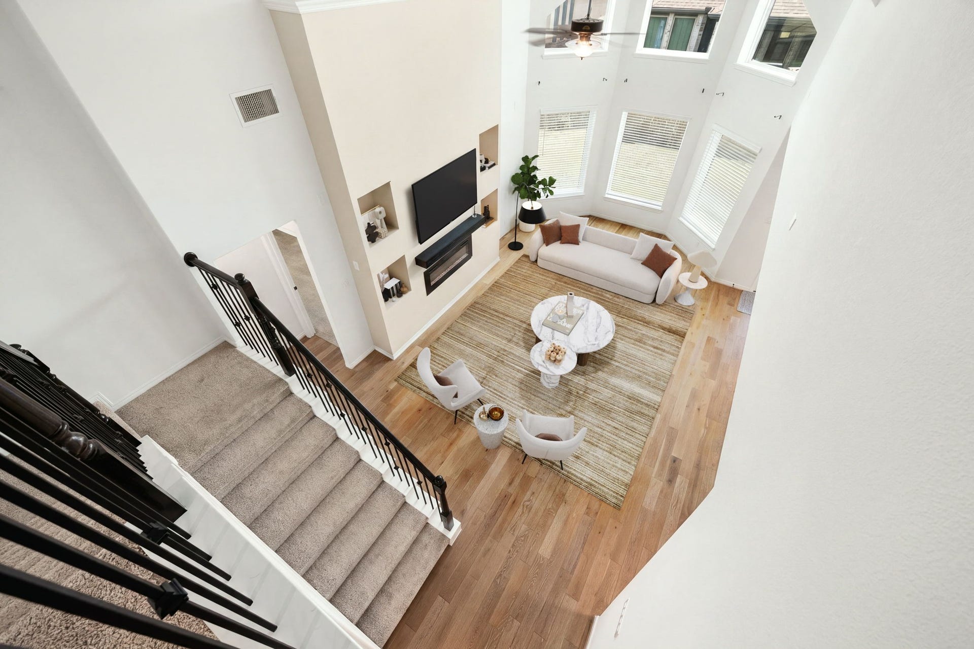 30715 Parkside Passage Drive, Fulshear, TX 77441 An incredible birds-eye view from the second-story overlook captures the grand scale and impressive architectural depth of the double-height great room. *VIrtually Staged