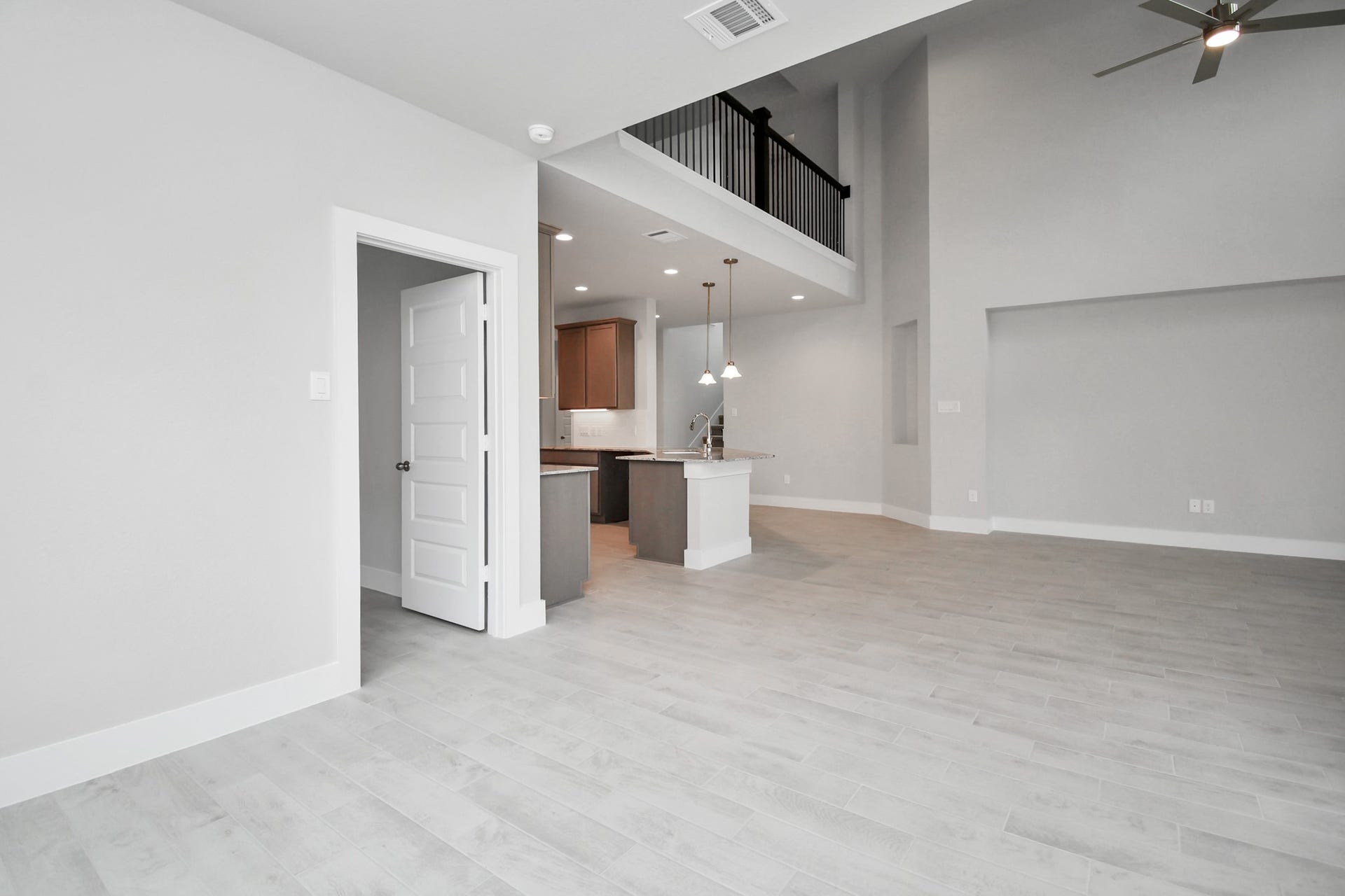 View from the breakfast area to the kitchen and living room. Sample photo of completed home with similar floor plan. Actual colors and selections may vary.