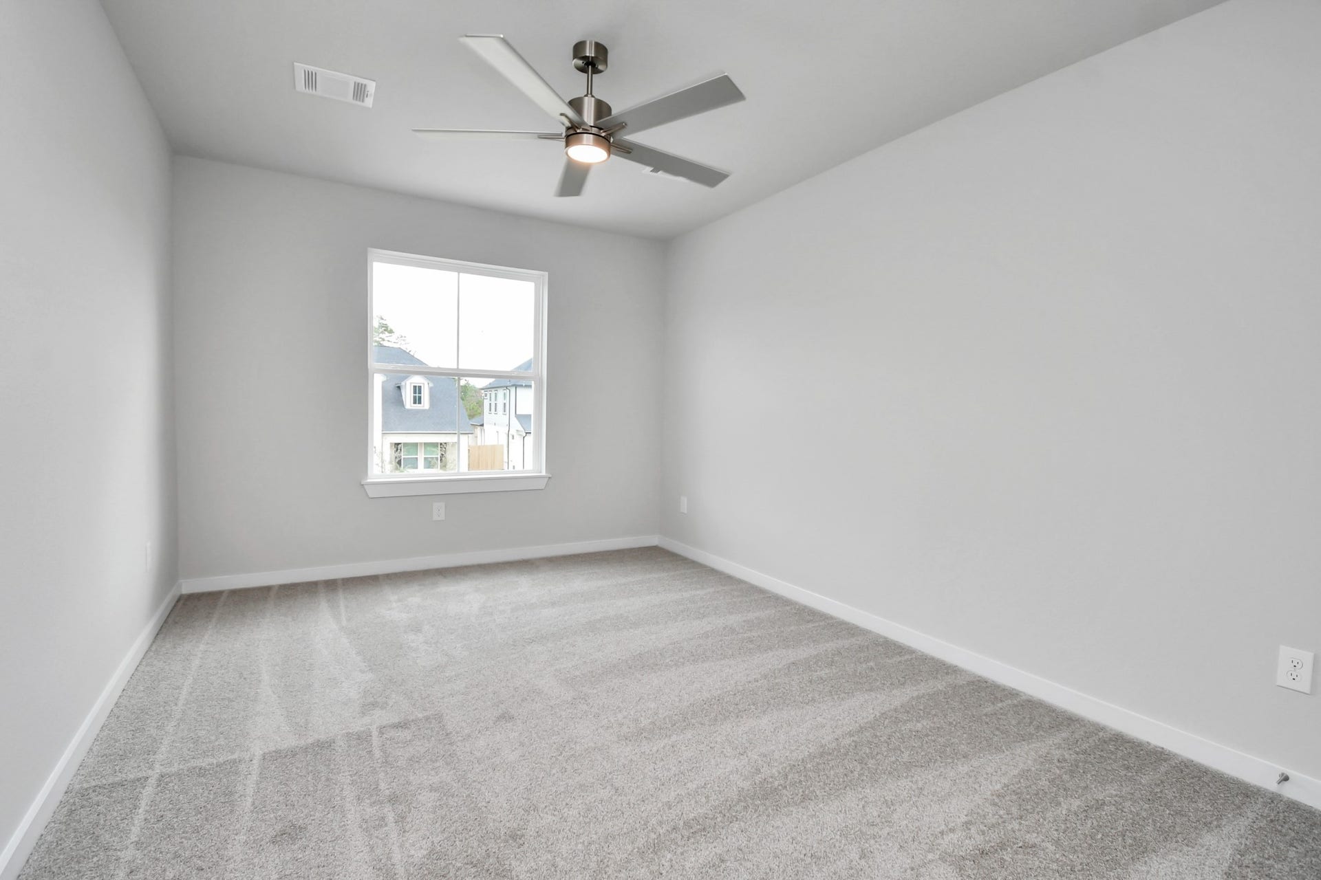 Secondary bedroom features plush carpeting, large windows that let in plenty of natural light, bright paint, and spacious closets. Sample photo of completed home with similar floor plan. Actual colors and selections may vary.